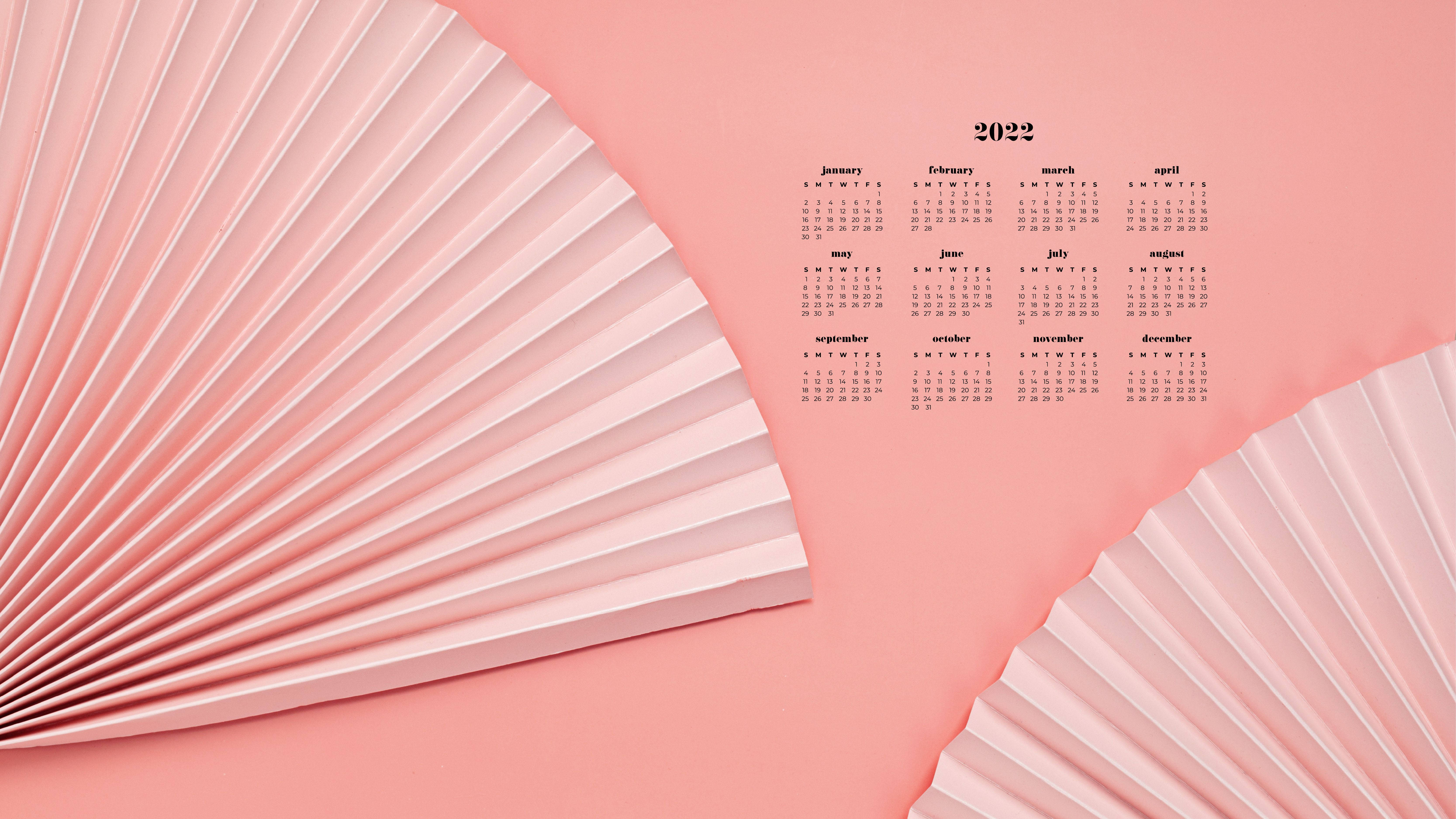 Calendar 桌布 壁紙 — 簡約2022年月曆，以柔和粉紅色背景襯托，並由兩個大型褶皺紙扇框住。