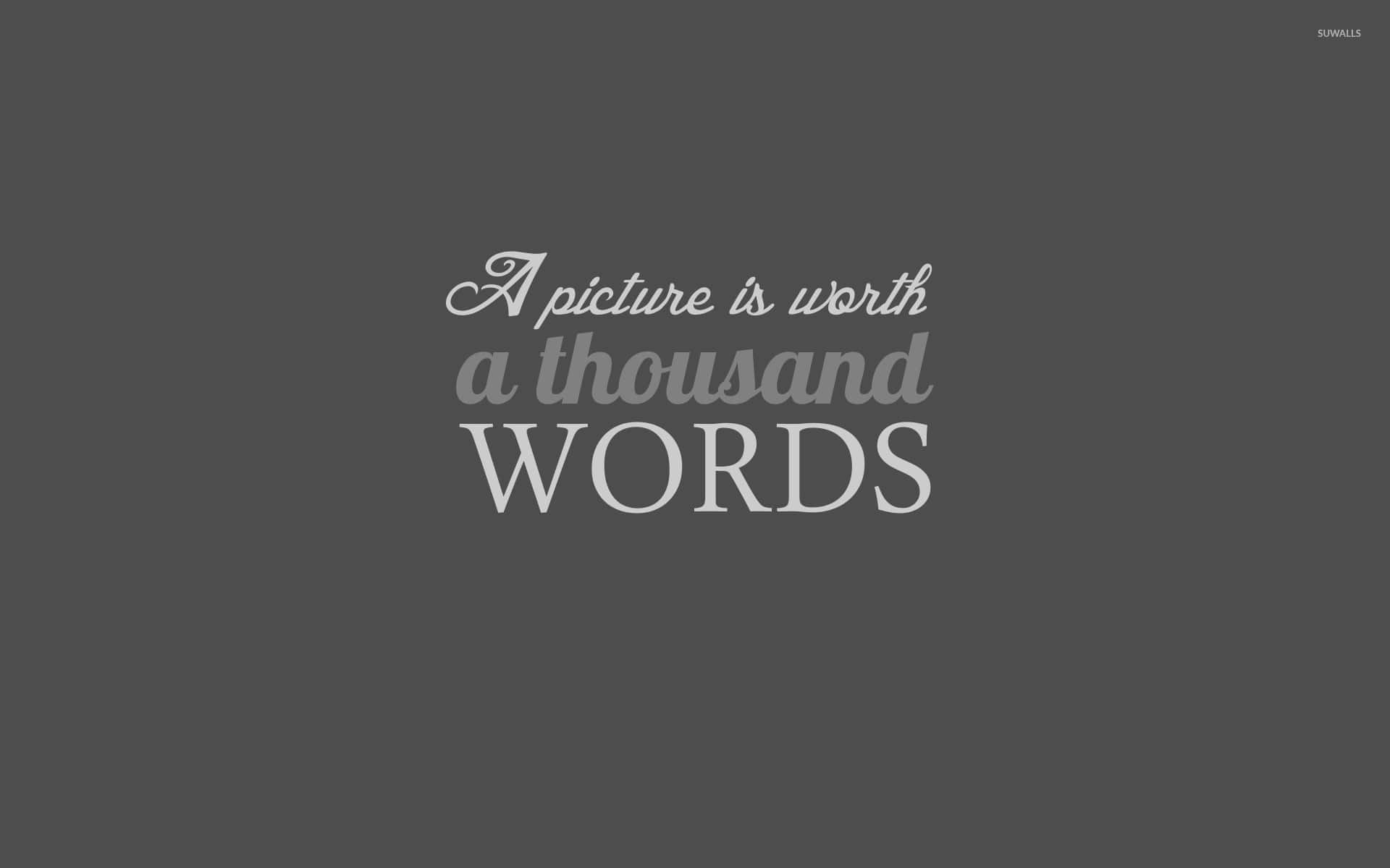 Worth 桌布 壁紙 — 簡約灰色背景，以混合字體優雅地呈現白色文字 'A picture is worth a thousand WORDS'。