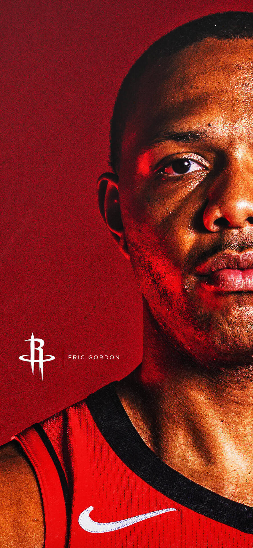 身穿紅色球衣的籃球運動員艾瑞克·戈登專注地看著鏡頭。 — Michael B Jordan 壁紙