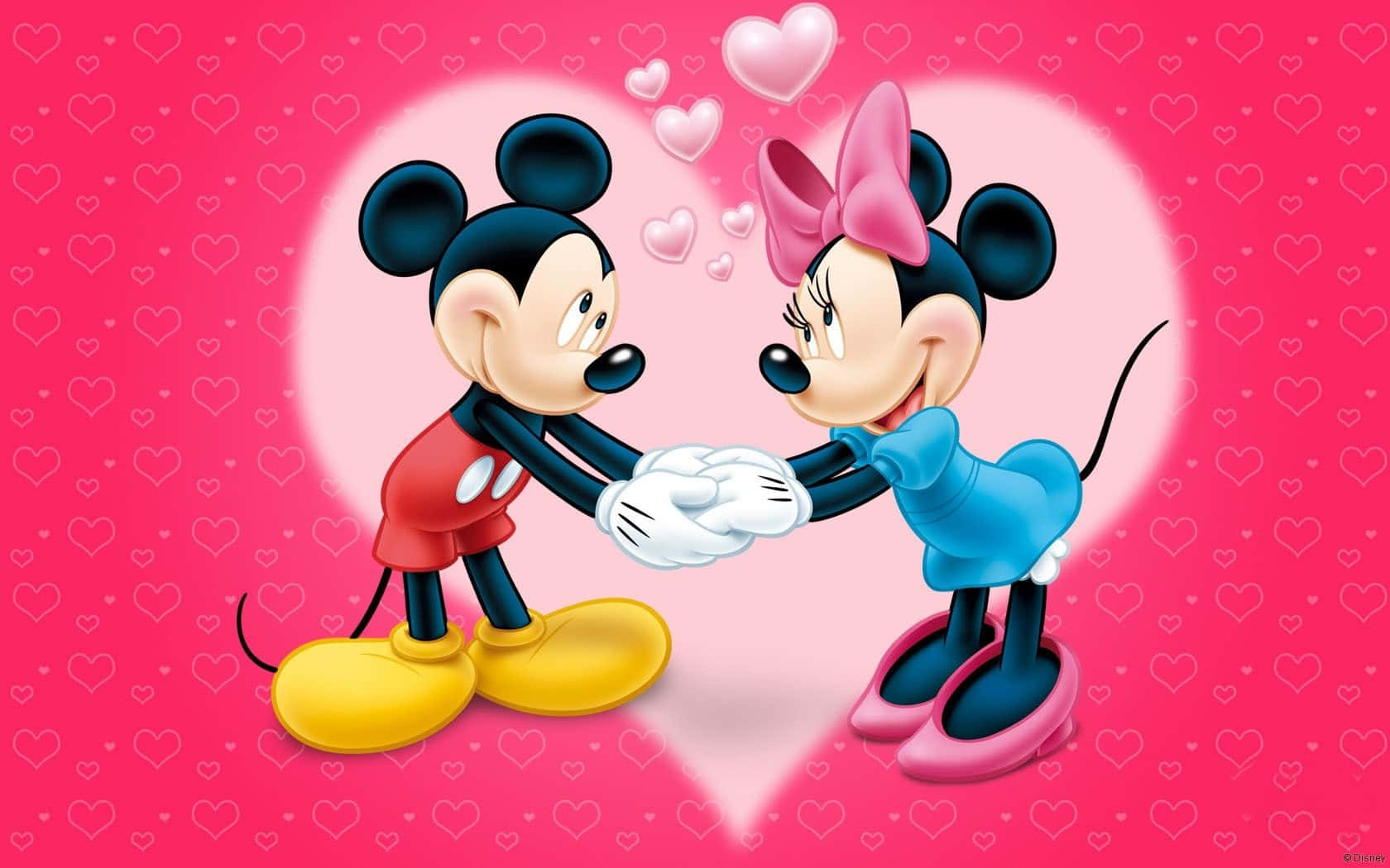Mickey And Minnie Mouse 桌布 壁紙 — 米奇和米妮老鼠在一個心形光芒中牽手，周圍漂浮著心形，背景是充滿活力的粉紅色。