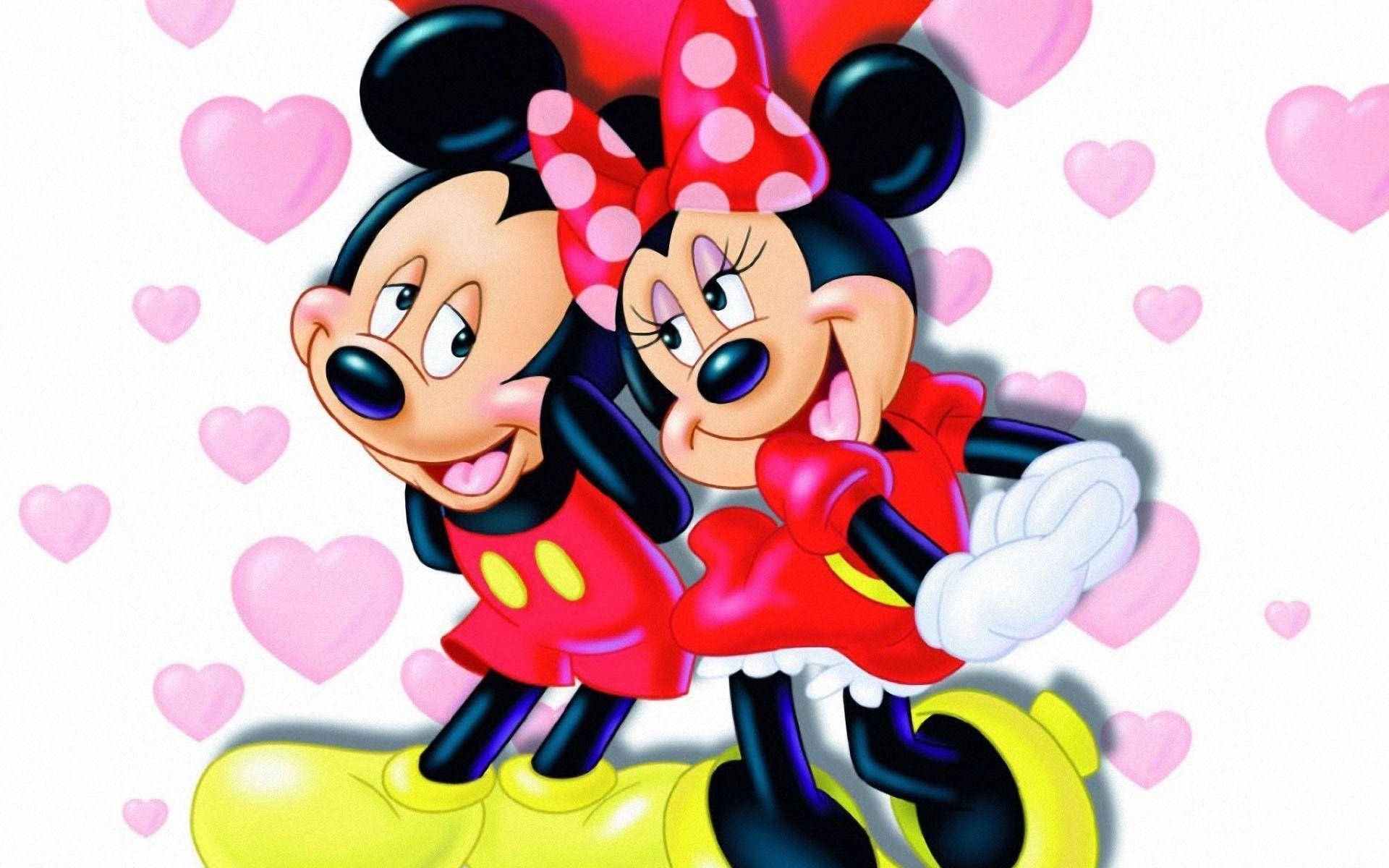 minnie 桌布 壁紙 — 米奇和米妮老鼠在漂浮的粉紅色心中快樂地擁抱，構成歡樂的卡通場景。