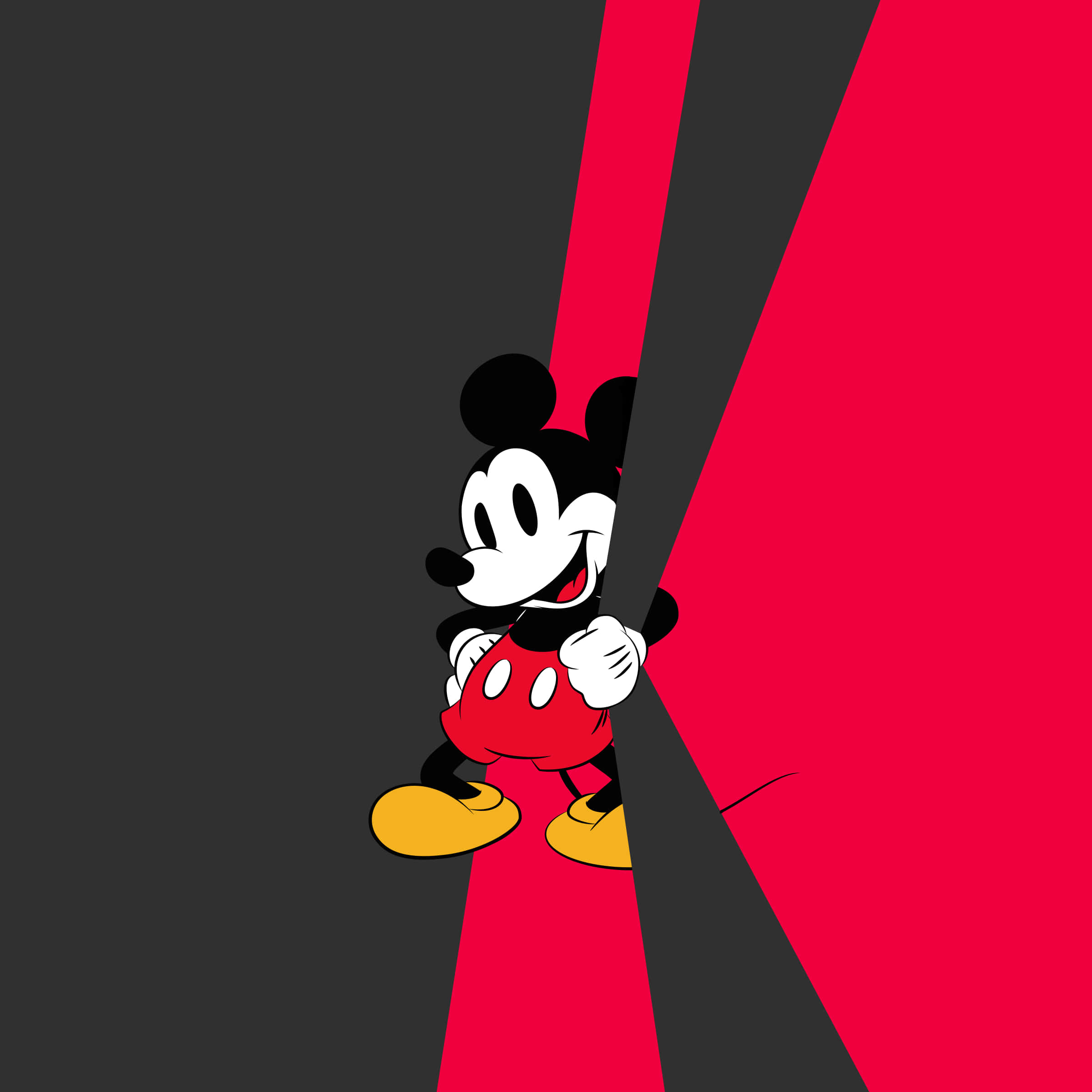Mickey Mouse Desktop 桌布 壁紙 — 米奇老鼠在大膽的紅黑斜線分割背景後面開心地探出頭來。