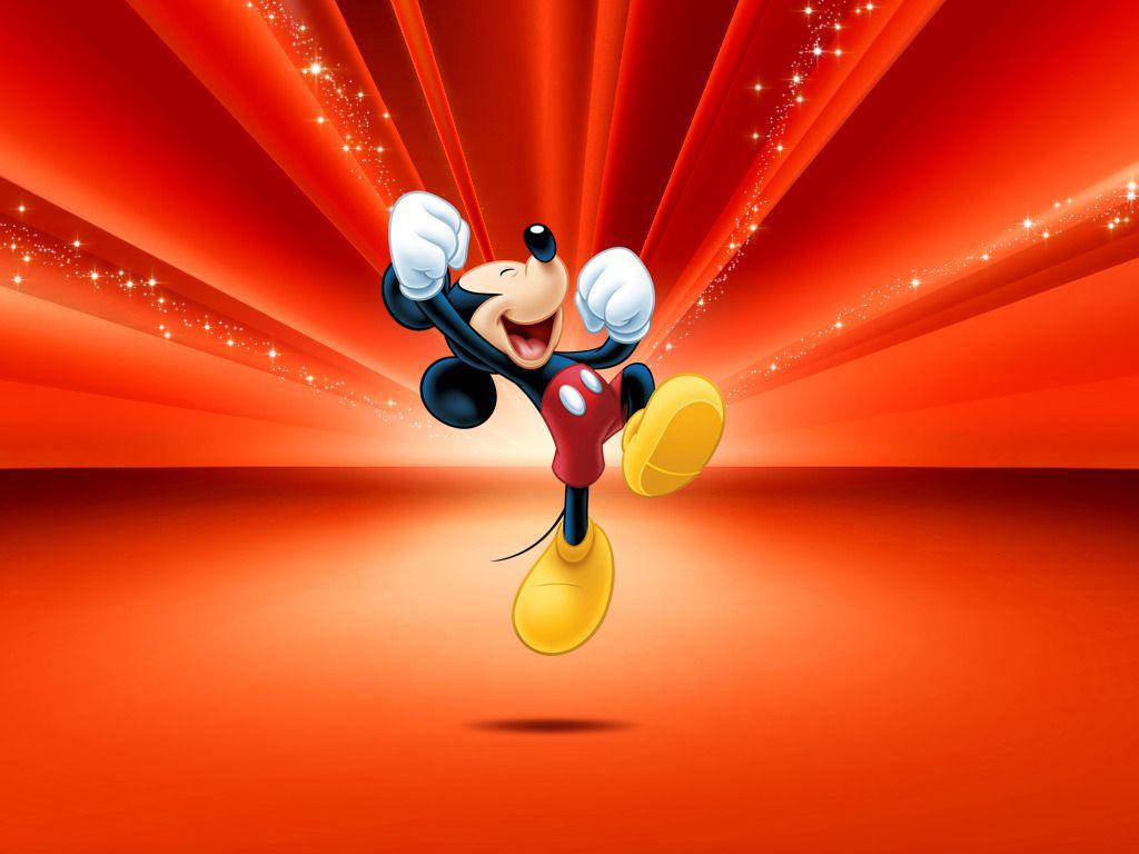 Mickey 桌布 壁紙 — 米奇老鼠在閃爍的紅色背景上，伴隨閃耀的光線，開心地跳躍。