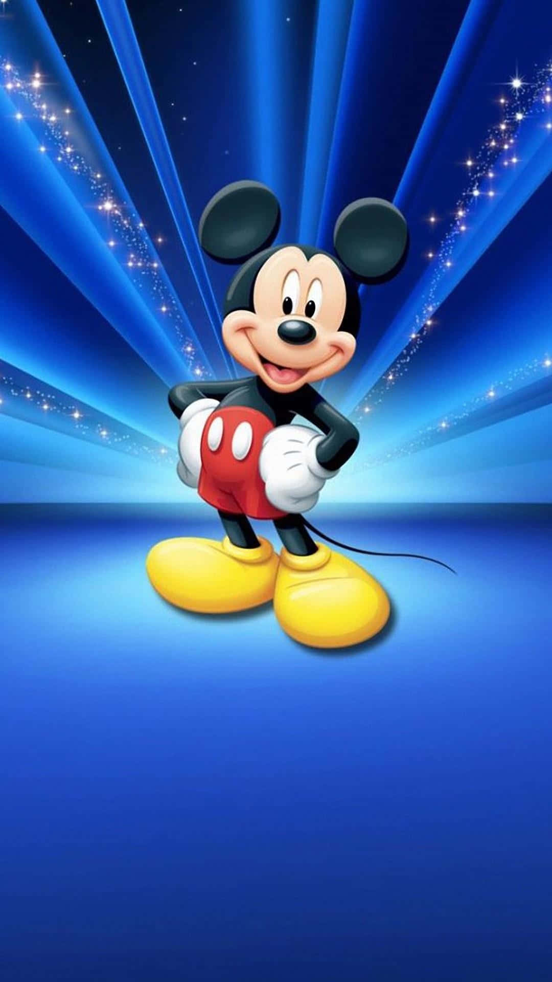 Cartoon Characters 桌布 壁紙 — 米奇老鼠在鮮豔的藍色背景前開心微笑，背後有閃爍的光線放射出來。