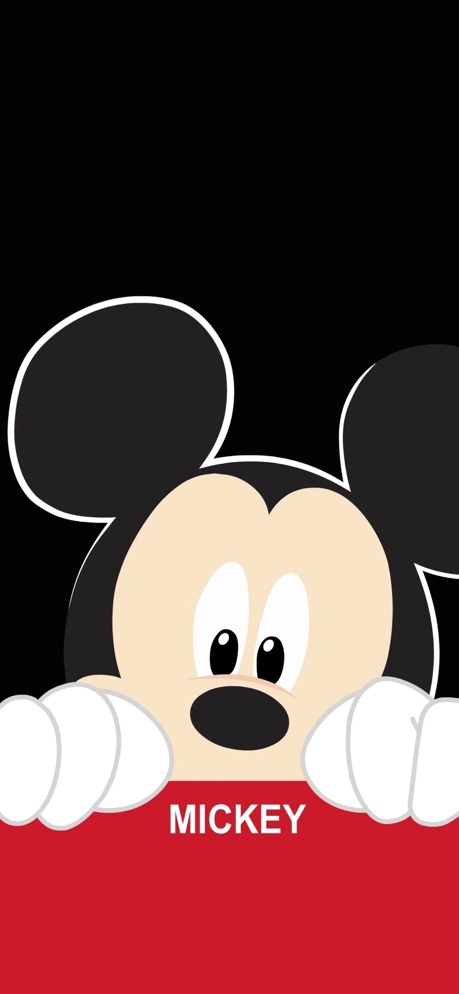 Mickey 桌布 壁紙 — 米奇老鼠在黑色背景上用大眼睛從紅色障礙物上方偷看。