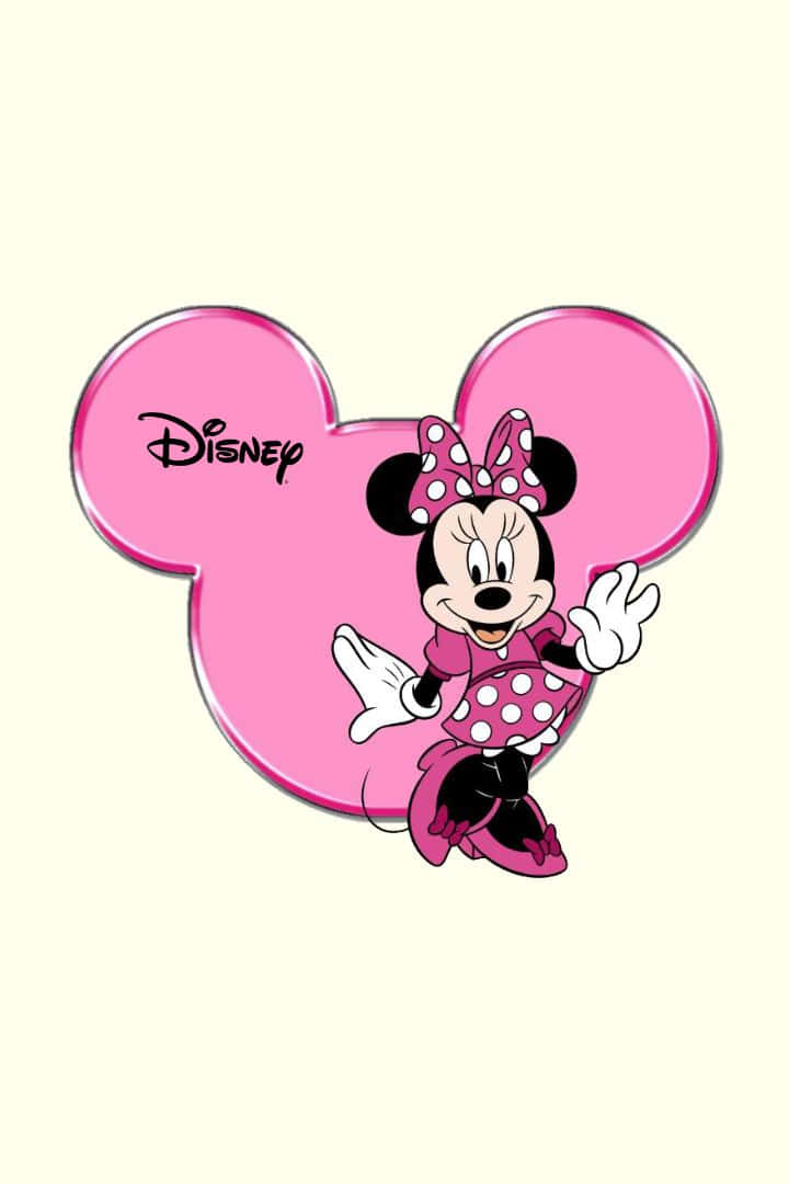 Minnie Mouse Pink 桌布 壁紙 — 米妮老鼠身穿粉紅色圓點裙，在閃亮的粉紅色米奇老鼠頭剪影內愉快地揮手。