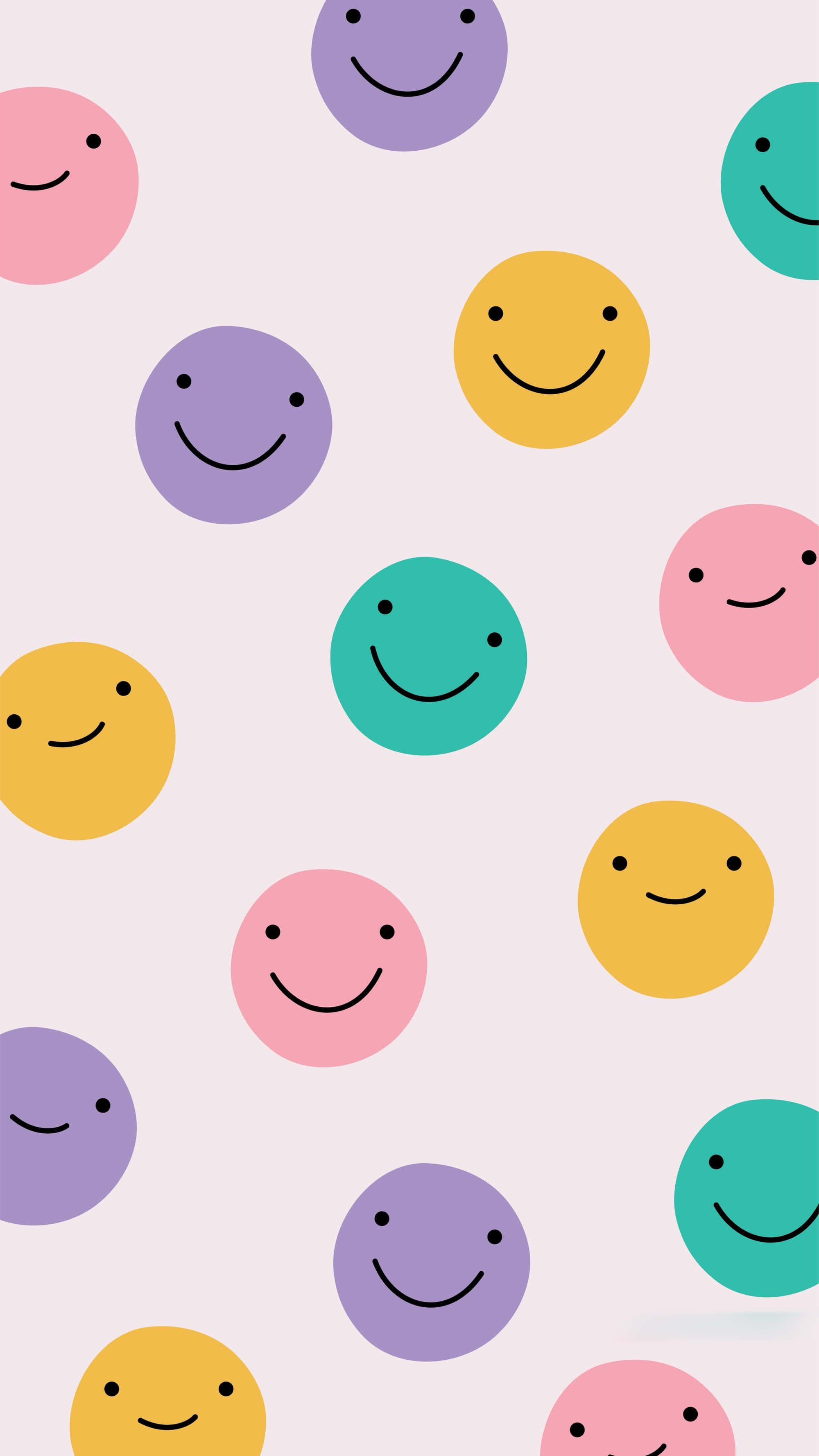 Smiley 桌布 壁紙 — 粉彩色微笑面孔漂浮在柔和的粉紅色背景上，營造出歡樂俏皮的圖案。
