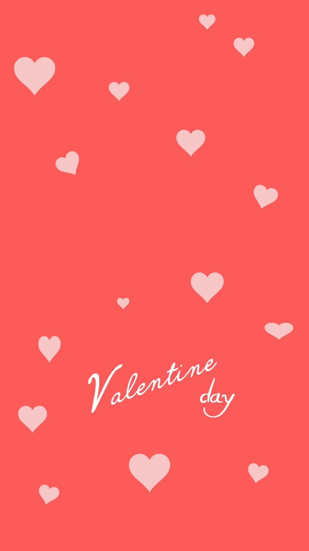 Valentines Day Phone 桌布 壁紙 — 粉紅心形在珊瑚色背景上輕輕飄浮，優雅的白色草書文字寫著情人節。