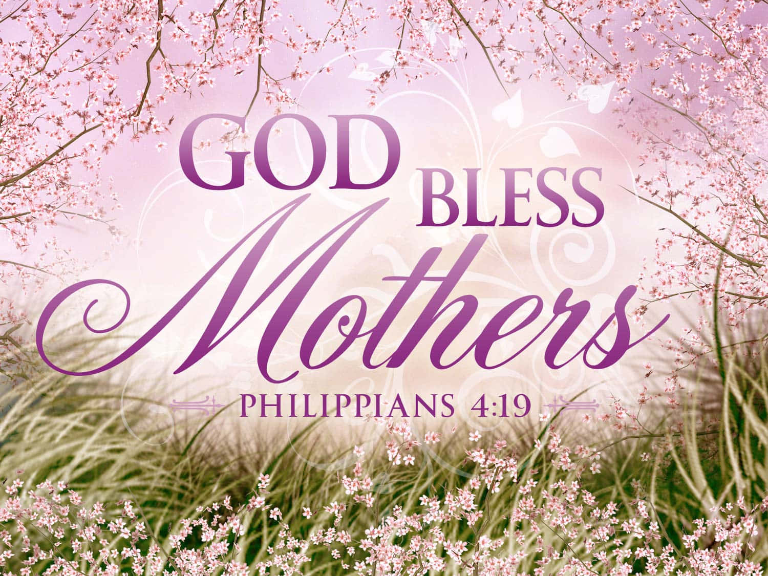 Woman 桌布 壁紙 — 粉紅櫻花框住優雅紫色文字「GOD BLESS Mothers」，在柔和粉彩天空下的野花田上。