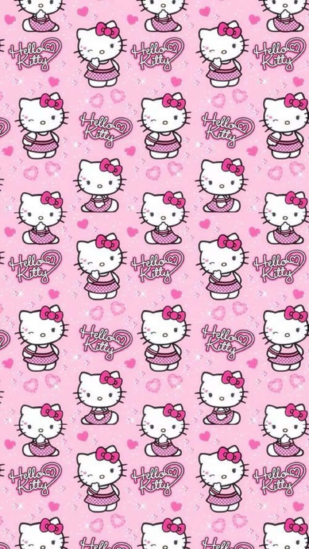 Kawaii Hello Kitty 桌布 壁紙 — 粉紅色壁紙，重複印有身穿波點裙的Hello Kitty角色和愛心圖案。