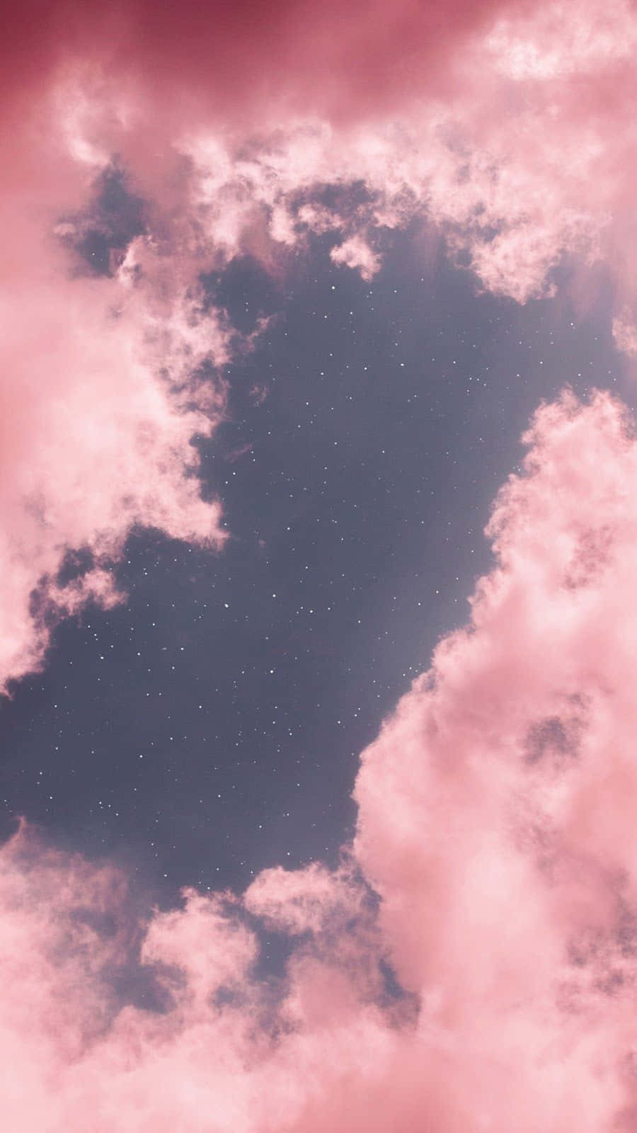 Stars 桌布 壁紙 — 粉紅色的雲彩框住了一個繁星點點的夜空，營造出夢幻般的天體場景。