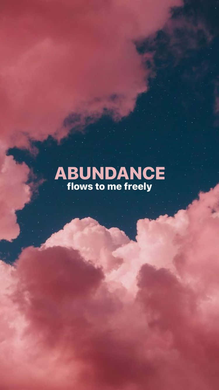 肯定語 桌布 壁紙 — 粉紅色的雲朵在繁星點點的夜空中飄移，文字 abundance flows to me freely 柔和地發光。