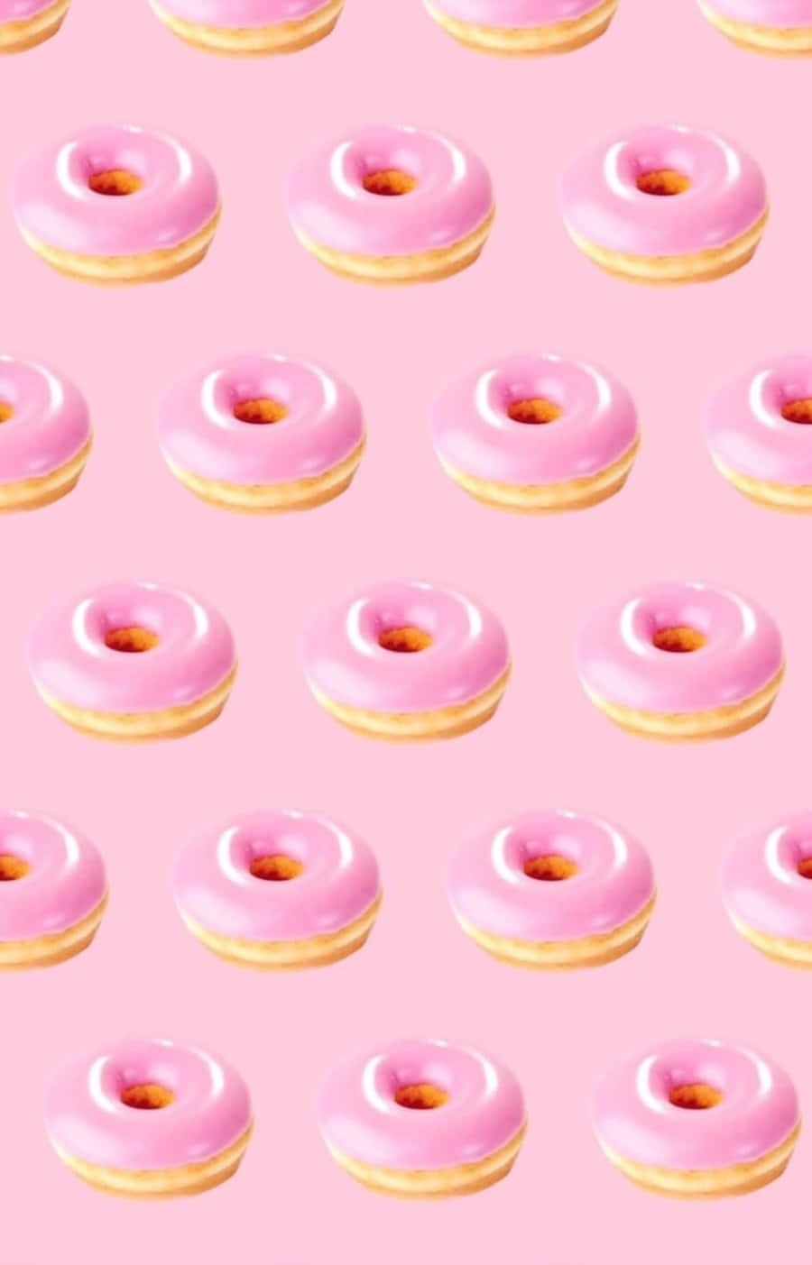 Kawaii Dessert 桌布 壁紙 — 粉紅色糖霜甜甜圈整齊排列在柔和的粉紅色背景上。