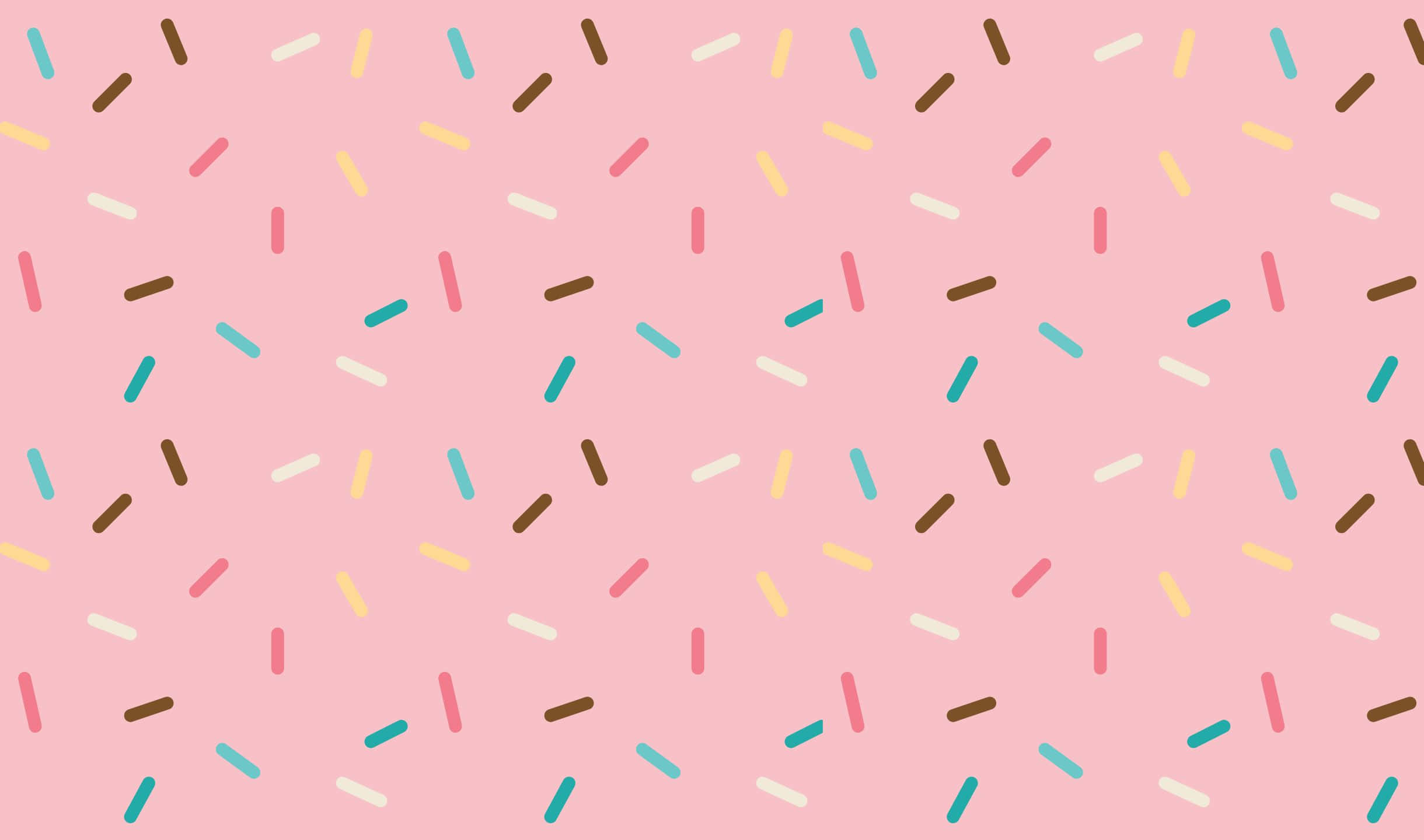 Sprinkles 桌布 壁紙 — 粉紅色背景上散落著棕色、黃色、粉紅色和藍綠色的彩色糖果粒。