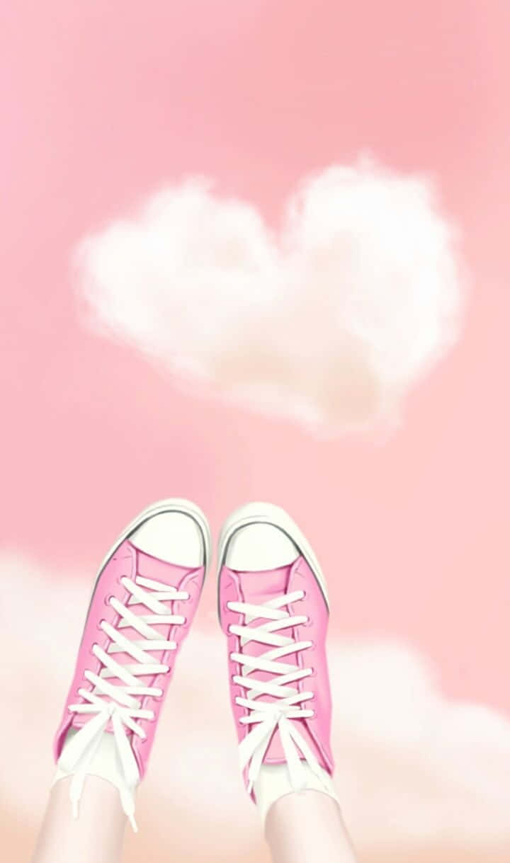 Cute Shoes 桌布 壁紙 — 粉紅色運動鞋漂浮在柔和的粉紅色天空上，上方有一朵蓬鬆的心形雲。