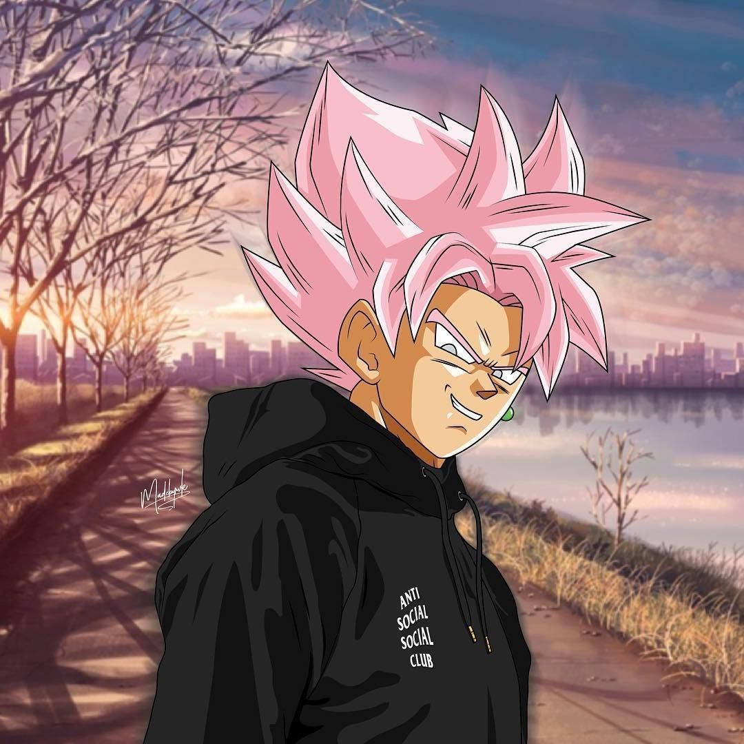 Goku Swag 桌布 壁紙 — 粉紅色頭髮的動漫角色穿著黑色連帽衫，站在日落時分水邊的小路上，城市天際線可見。