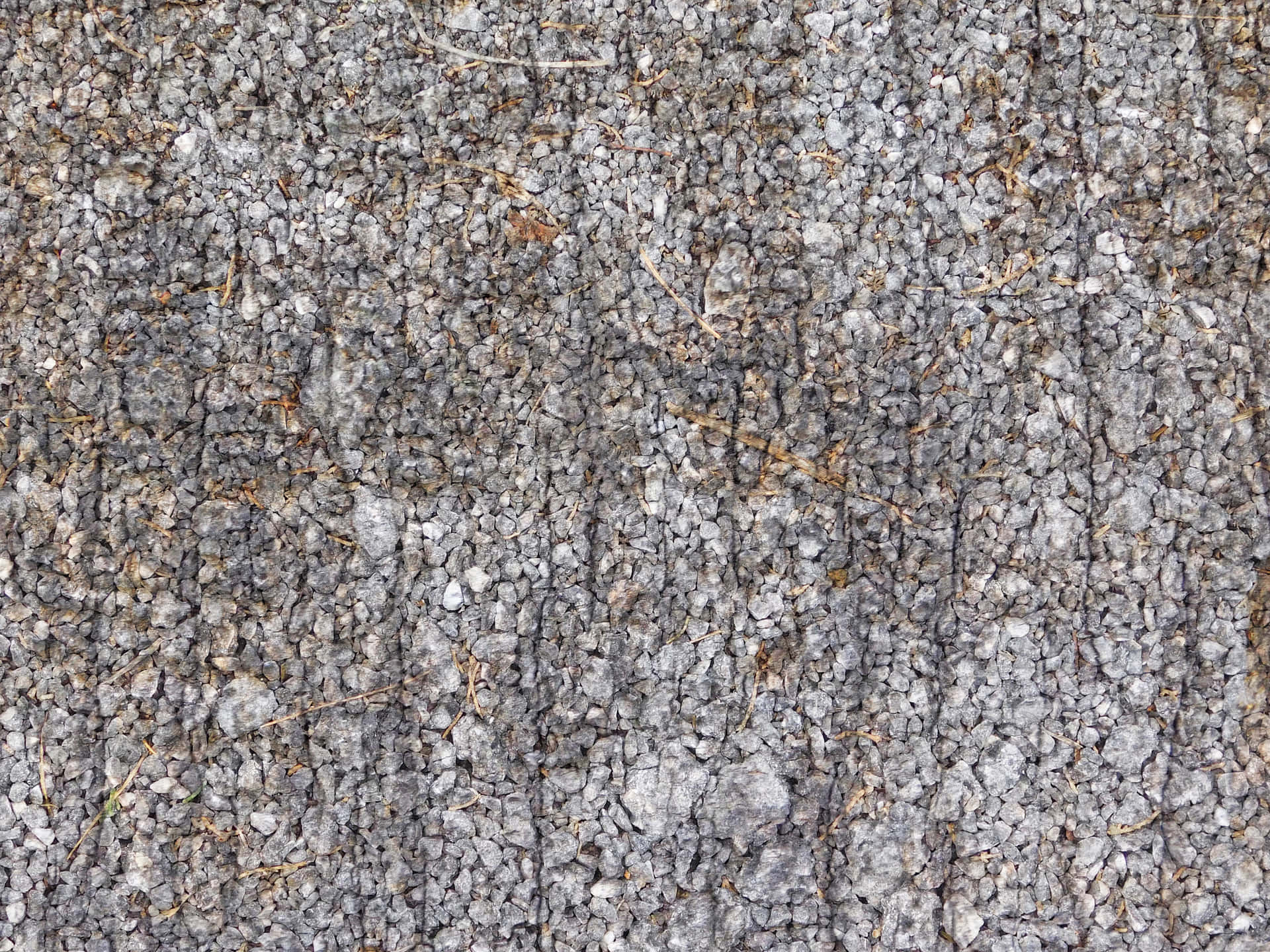 Stone texture 壁紙 — 粗糙灰色礫石表面的特寫，散落著乾草和細微裂縫。