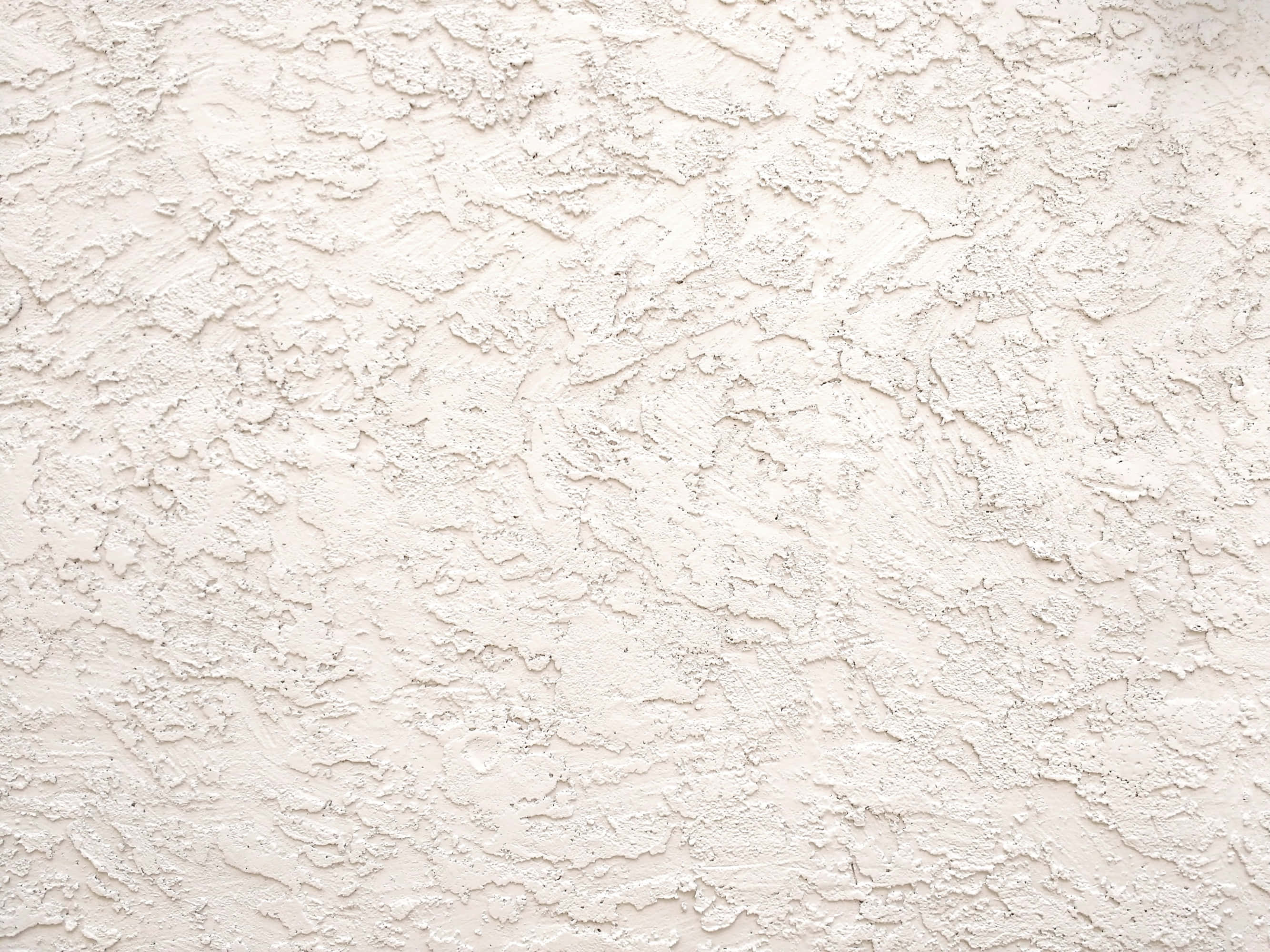 Rough Texture 桌布 壁紙 — 粗糙白色灰泥牆的近距離特寫，紋理不均勻，帶有微妙的灰色調。