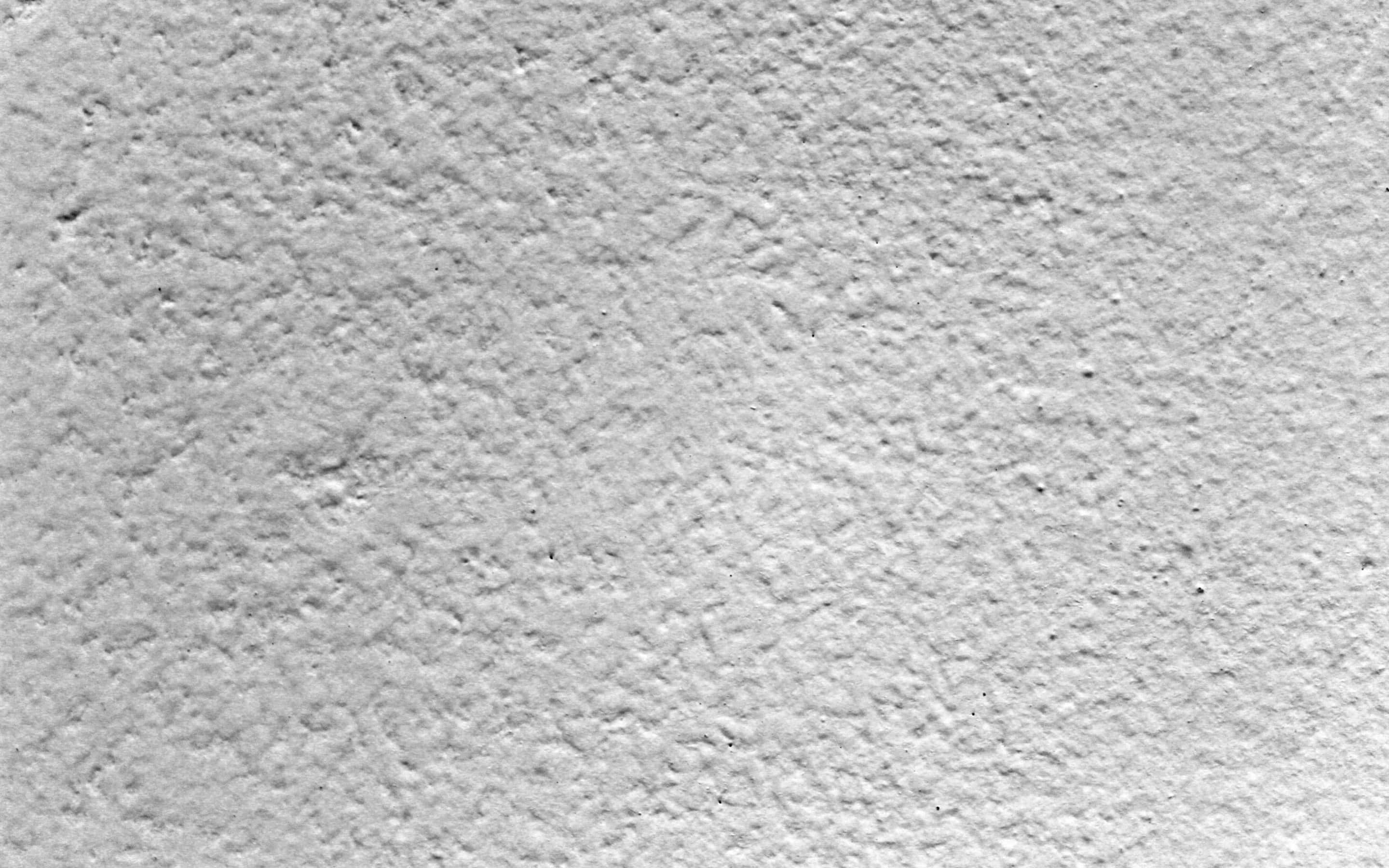 Rough Texture 桌布 壁紙 — 粗糙紋理白色灰泥牆的特寫，帶有微妙的灰色變化和細小瑕疵。