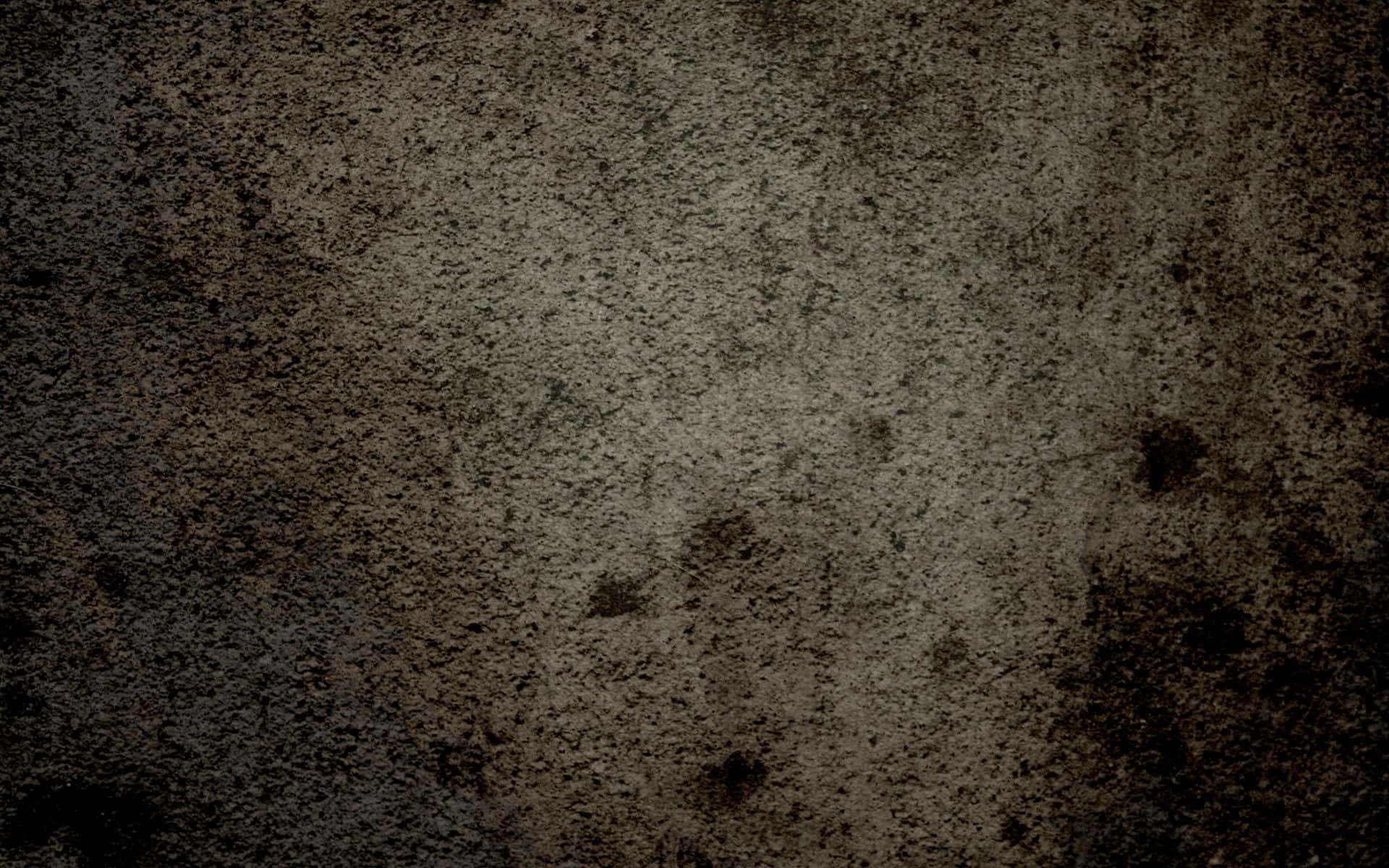 Dirt 桌布 壁紙 — 粗糙紋理表面，帶有斑駁的深棕色和灰色色調，顯示磨損痕跡。