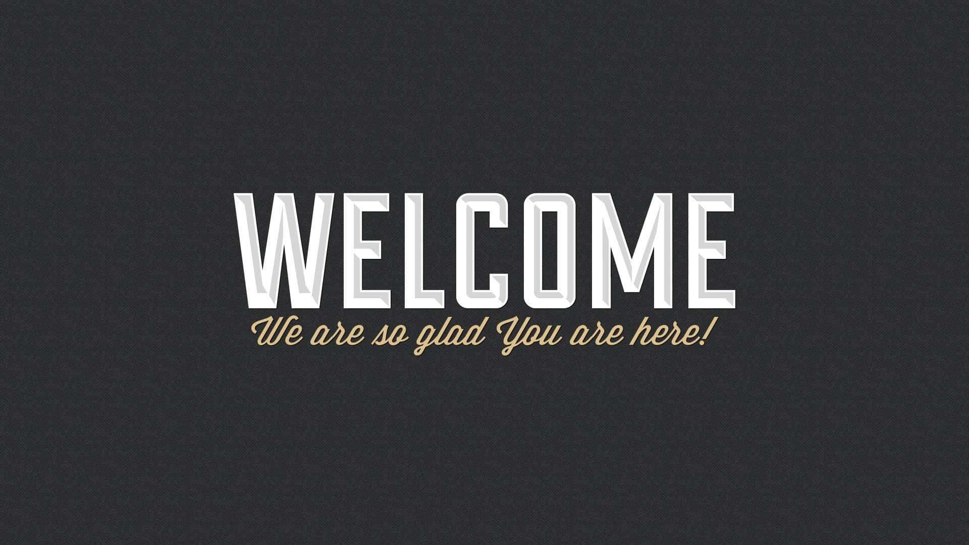 Welcome 桌布 壁紙 — 粗體白色 'WELCOME' 文字，下方有金色手寫字體，背景為紋理深灰色。