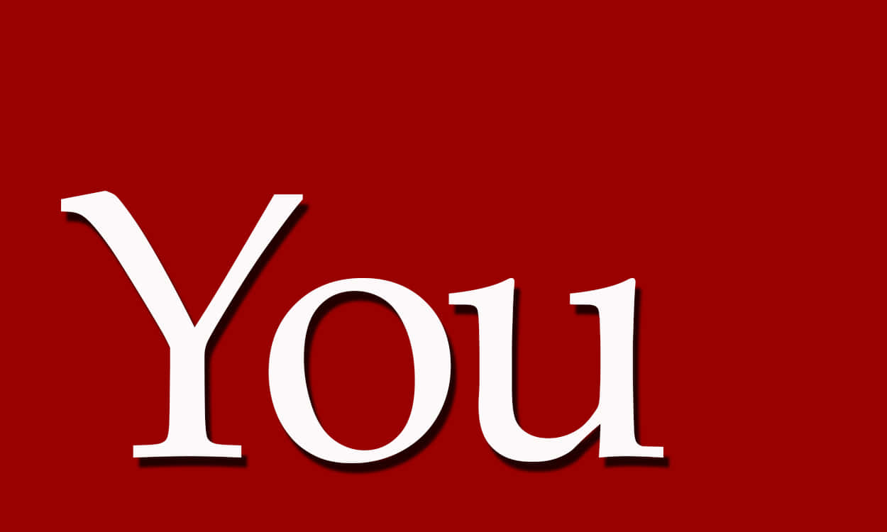 You 桌布 壁紙 — 粗體白色襯線字體的「You」一詞在純深紅色背景上帶有微妙陰影，顯得格外突出。