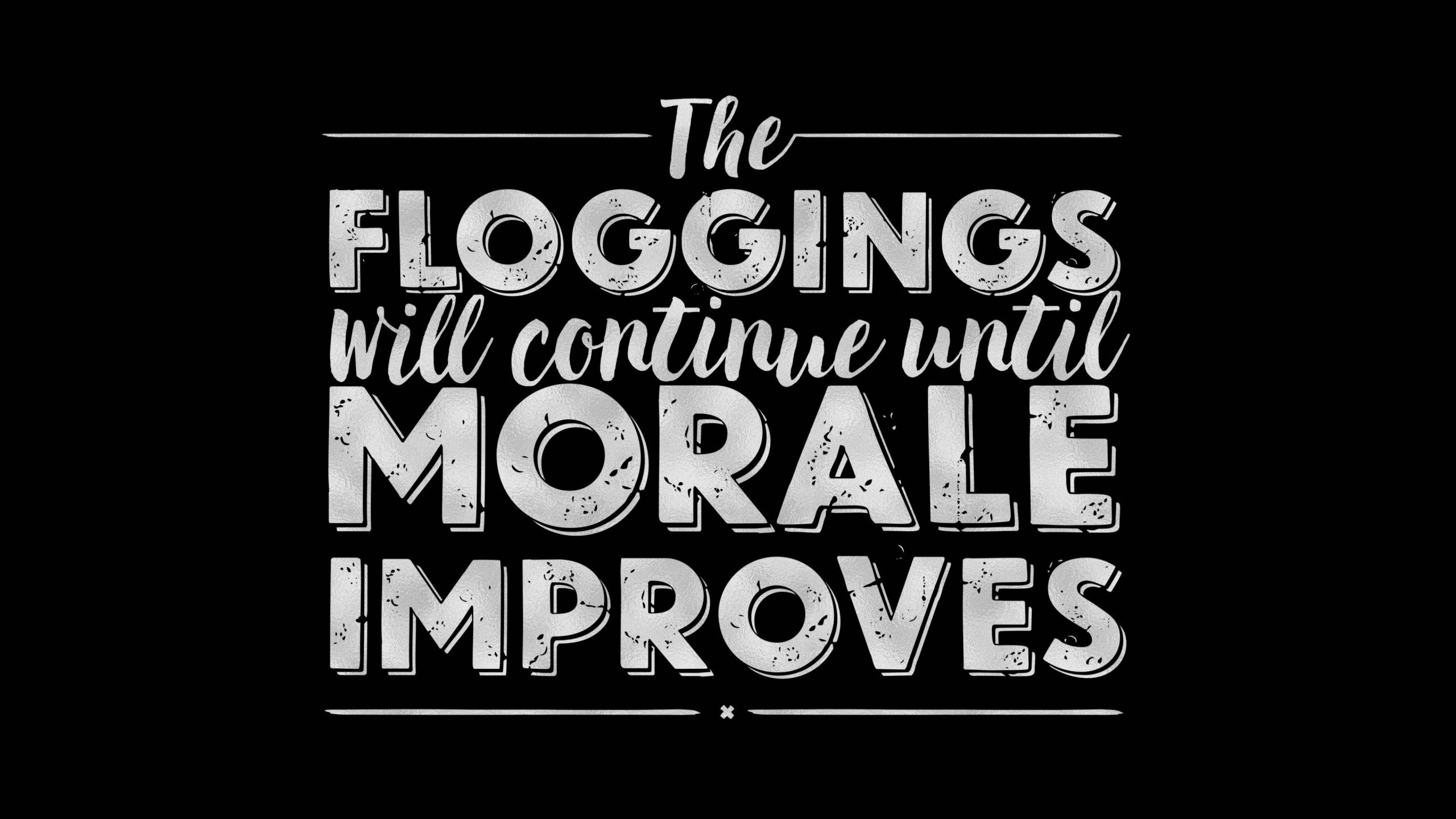 HD inspirational 桌布 壁紙 — 粗體破舊字體在純黑背景上宣告「The Floggings will continue until morale improves」。