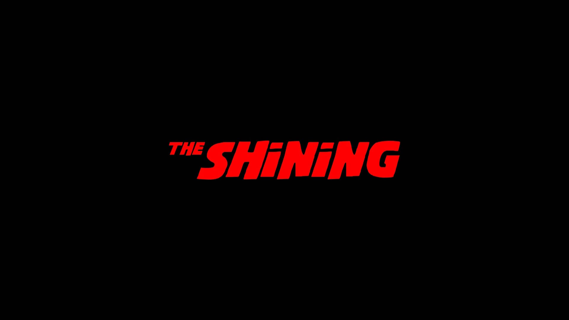 shining 桌布 壁紙 — 粗體紅色 'THE SHINING' 標題，採用風格化字體，居中於簡潔的黑色背景上。