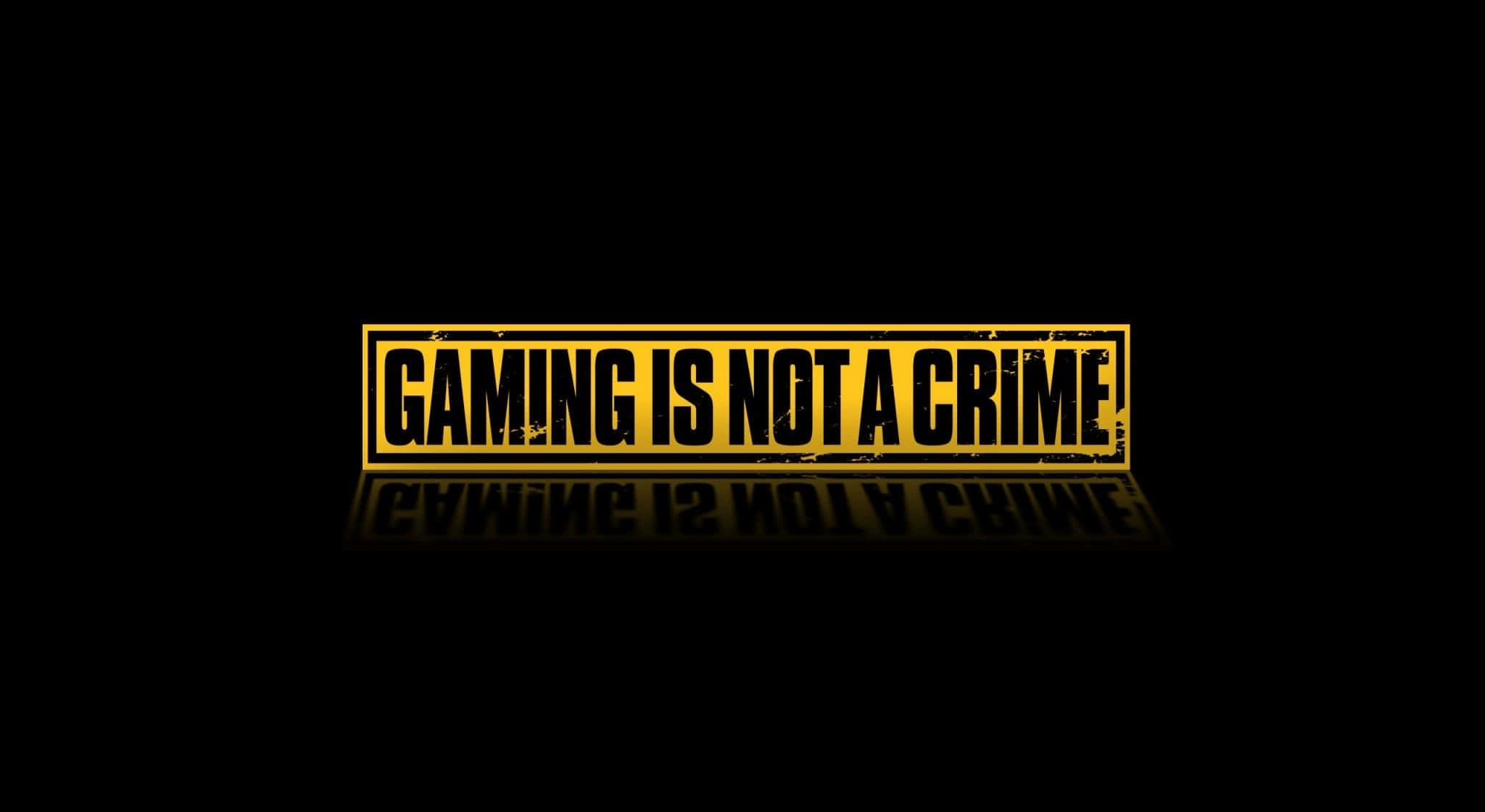 Pro Gamer 桌布 壁紙 — 粗體黃色文字宣稱遊戲不是犯罪，背景為純黑色並帶有微妙反射。