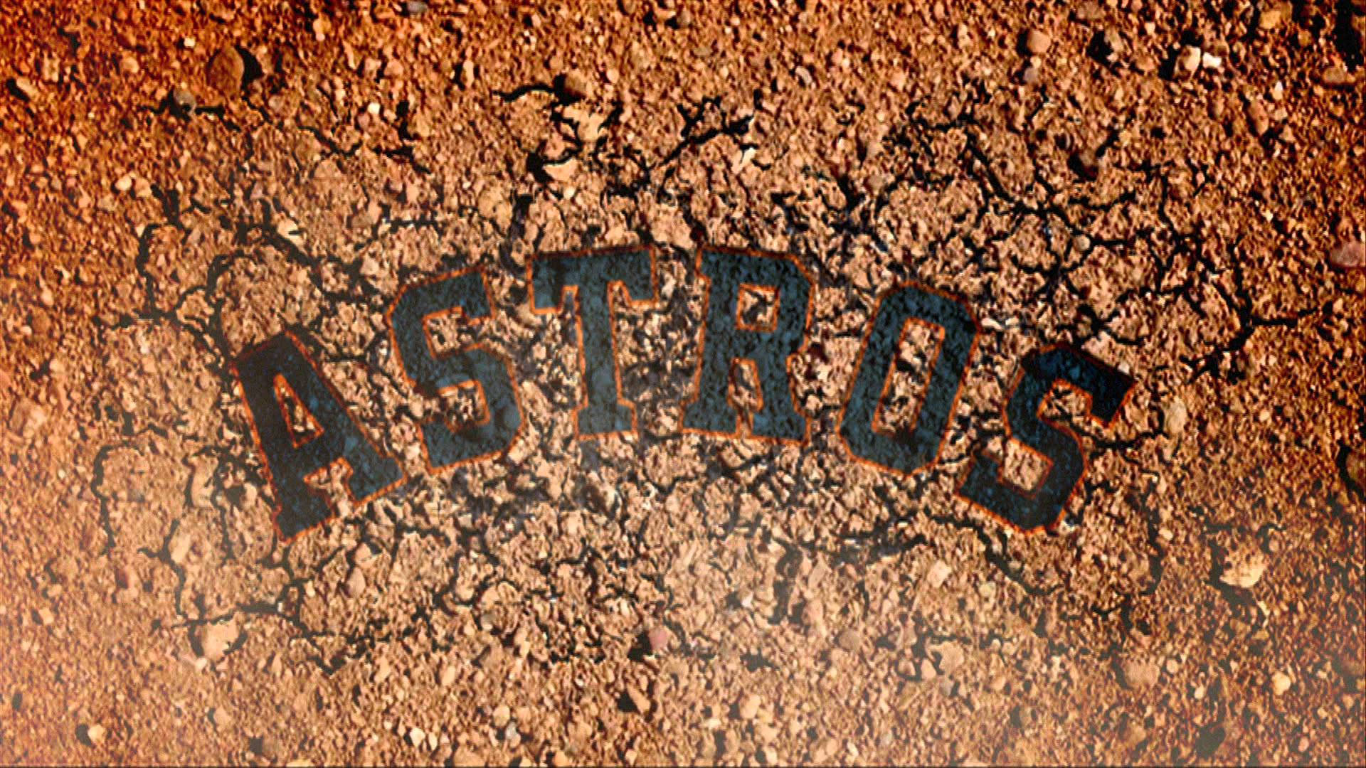Astros 桌布 壁紙 — 粗體黑色 'ASTROS' 字母嵌入裂開的紅褐色泥土中，帶有粗糙質感。