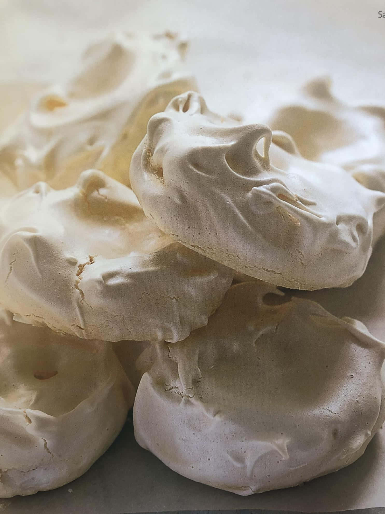 Meringue 桌布 壁紙 — 精緻白色蛋白霜餅乾的特寫，帶有柔軟的尖峰和輕盈質感。