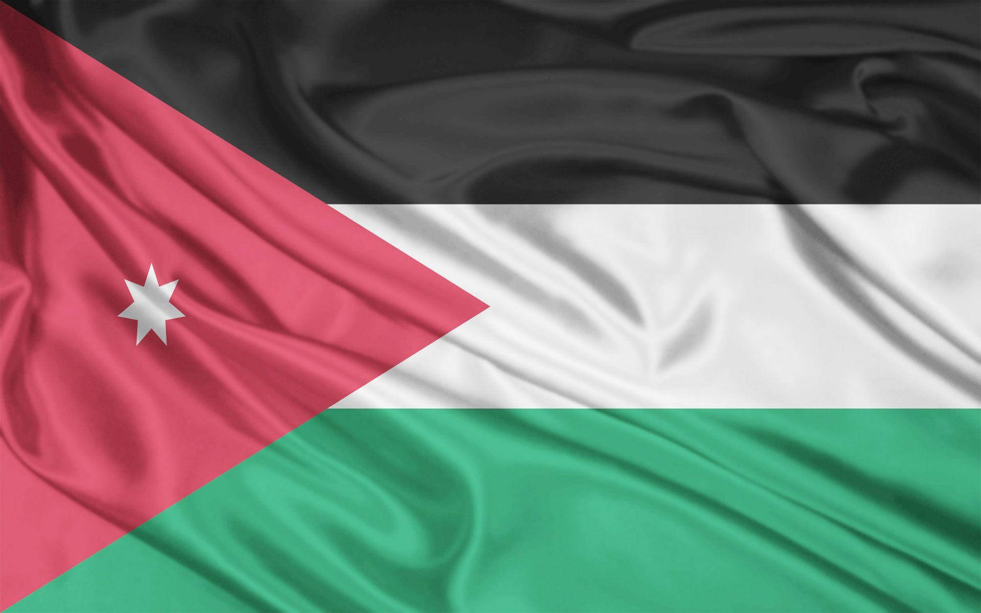 Jordan 桌布 壁紙 — 約旦國旗動態飄揚，帶有濃郁的紅、黑、白、綠色以及一顆白色的七角星。