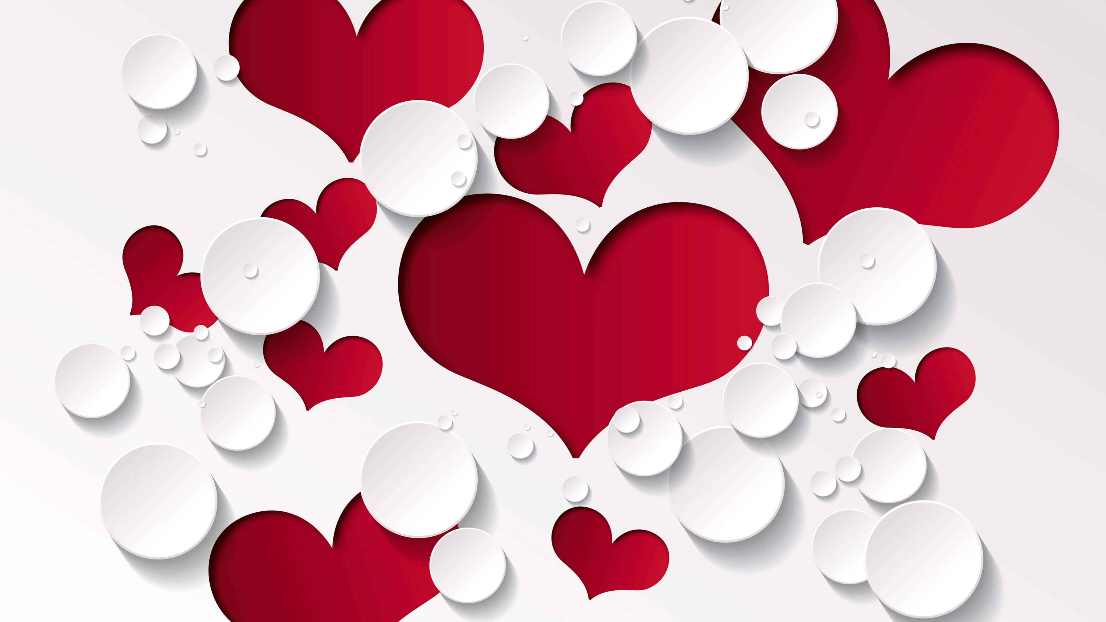 4K Love 桌布 壁紙 — 紅色和白色的紙製心形和圓形在柔和的灰色背景上動態漂浮，帶有微妙的陰影。