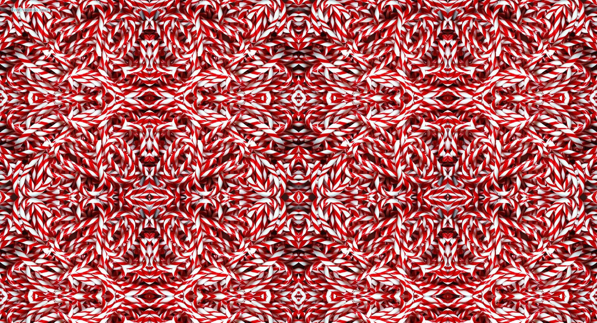 Candy Cane 桌布 壁紙 — 紅色和白色糖果手杖以對稱、重複的星爆圖案排列的萬花筒圖案。