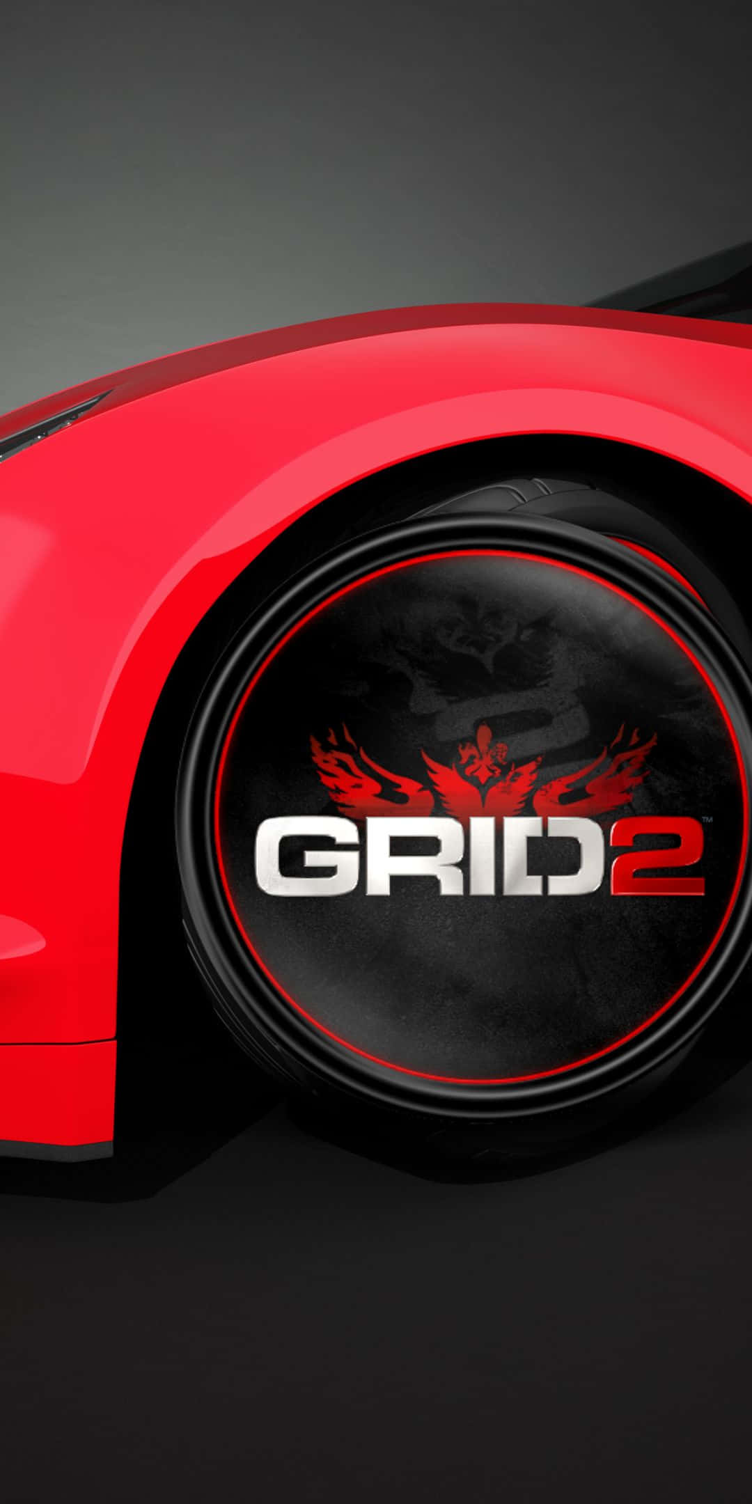 video games 桌布 壁紙 — 紅色跑車車輪的特寫，帶有GRID 2標誌和火焰翅膀，背景為深色。