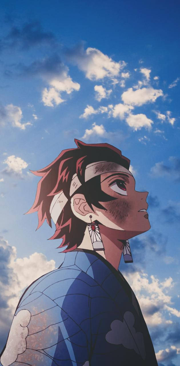 紅髮白頭帶的動漫角色仰望藍天白雲。 — 鬼滅之刃 iPhone 桌布 壁紙