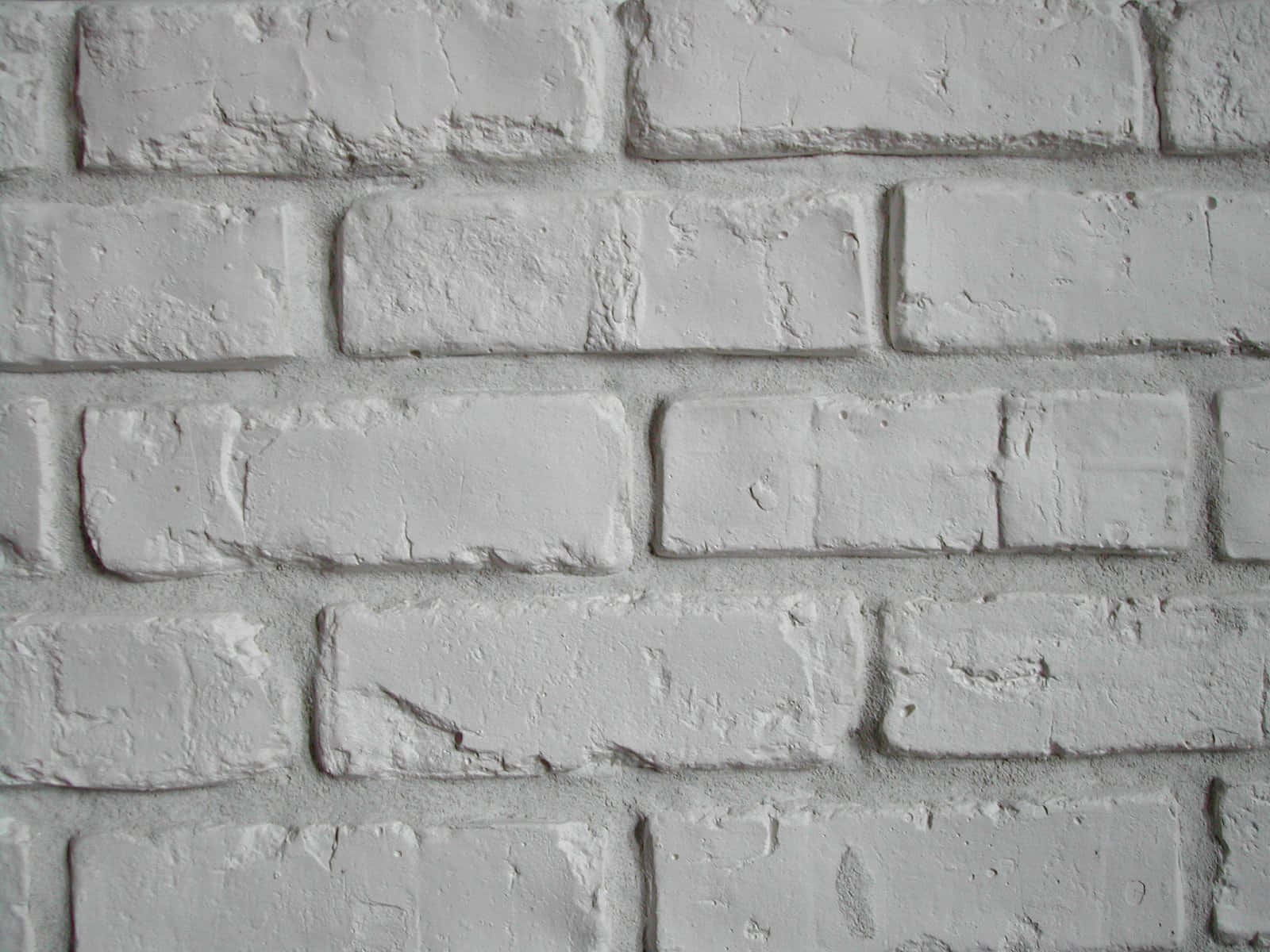 White Wall 桌布 壁紙 — 紋理白色油漆磚牆的特寫，顯示磨損的砂漿和微妙的灰色底色。
