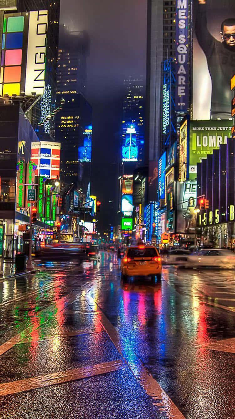 New York City Night iPhone 桌布 壁紙 — 紐約市夜晚一條被雨水浸濕的街道，反射著高聳廣告牌和發光招牌的霓虹燈光。