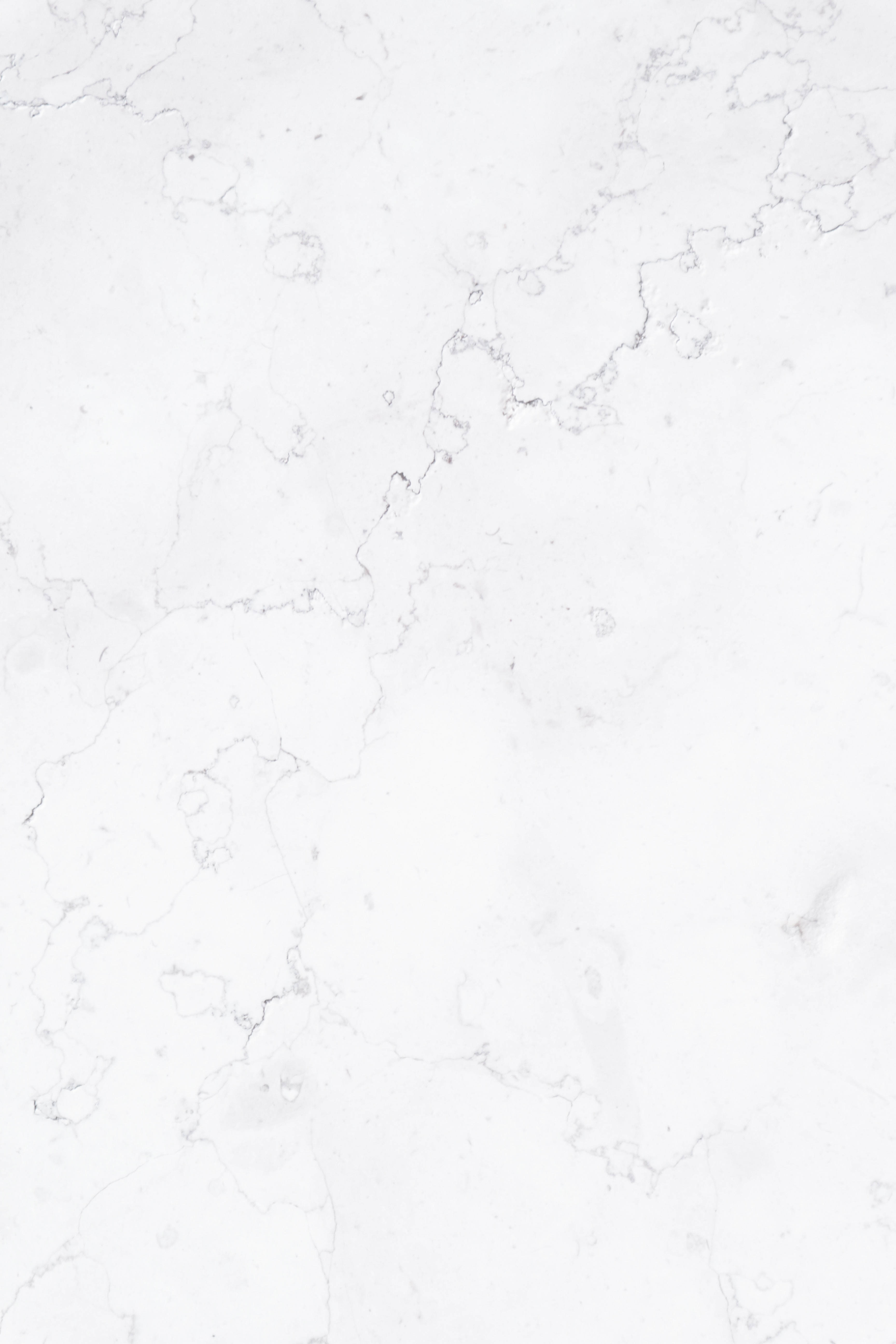 White Texture 桌布 壁紙 — 純白大理石的特寫，帶有細膩的灰色紋理，營造出優雅的自然圖案。