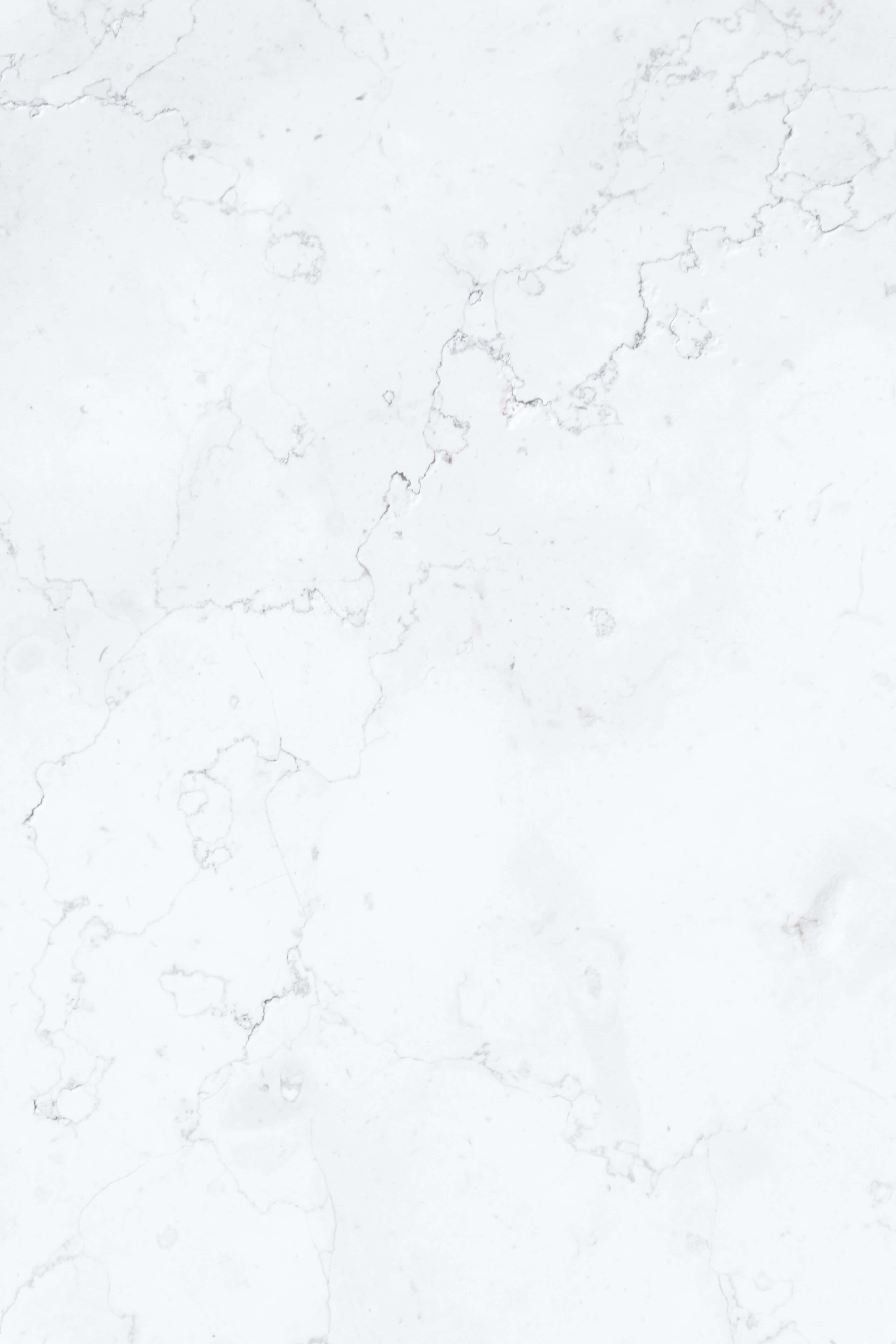 White Marble 桌布 壁紙 — 純白大理石近距離特寫，帶有細膩灰色紋理和微妙質感。