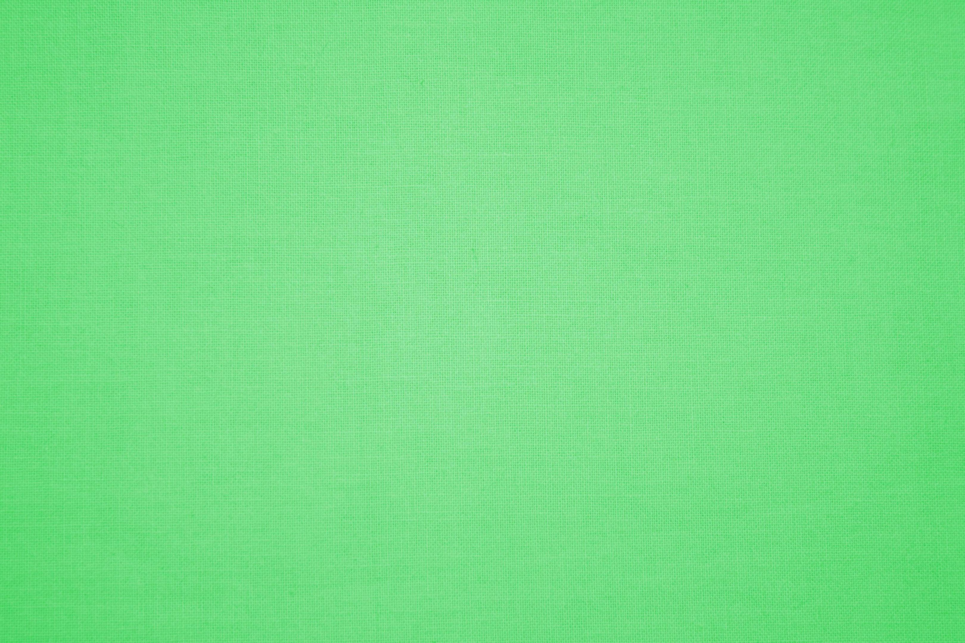 Plain Color 桌布 壁紙 — 純綠色布料表面，帶有微妙的編織紋理和均勻照明。