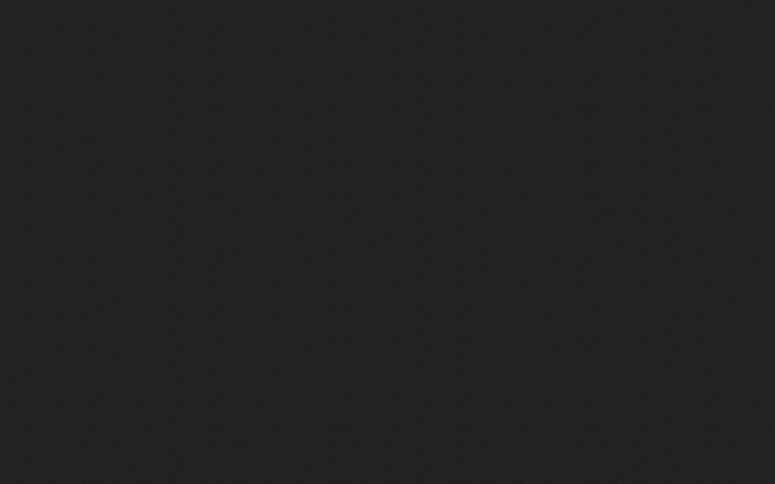 Solid Dark Grey 桌布 壁紙 — 純色深灰色紋理背景，帶有細微顆粒和均勻色調。