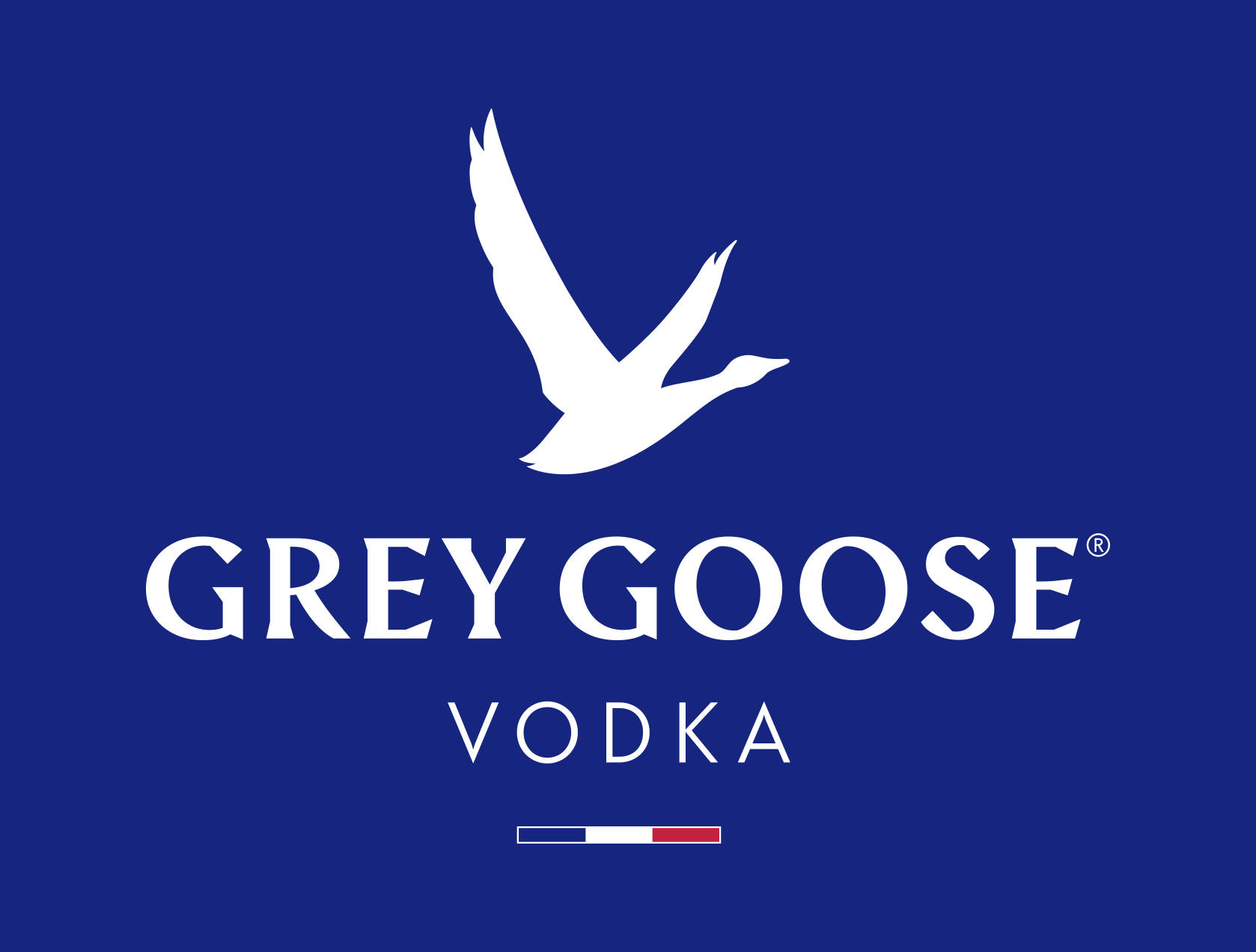 飲料 桌布 壁紙 — 純藍色背景上，Grey Goose Vodka 標誌上方有一隻白色飛翔鵝的剪影。