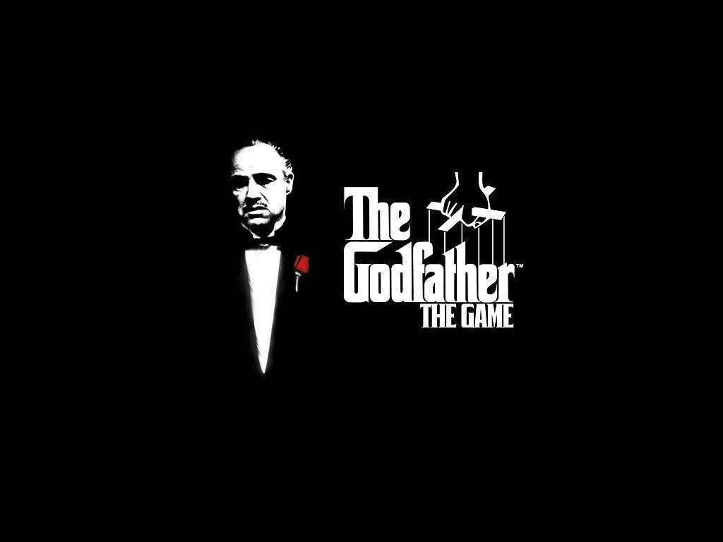 Godfather 桌布 壁紙 — 純黑背景上，有一個穿著禮服、手持紅玫瑰的白色男子剪影，以及遊戲標題「The Godfather The Game」的粗體白色文字。