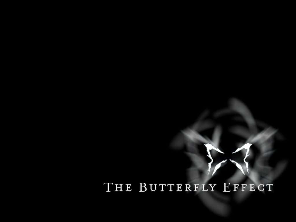 Butterfly Effect 桌布 壁紙 — 純黑色背景上有一個帶動態模糊的發光白色蝴蝶剪影，下方有「THE BUTTERFLY EFFECT」文字。