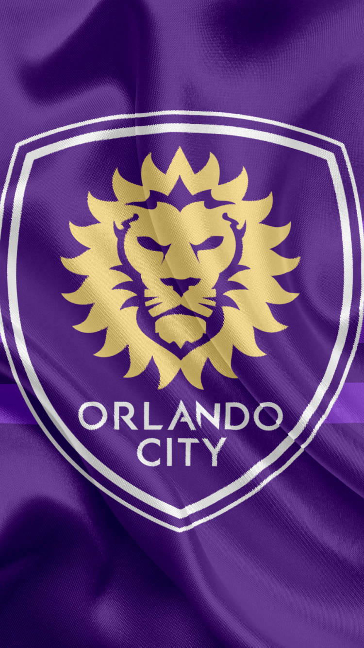 足球 桌布 壁紙 — 紫色布料背景上有一個金色獅子標誌，下方有「ORLANDO CITY」文字。