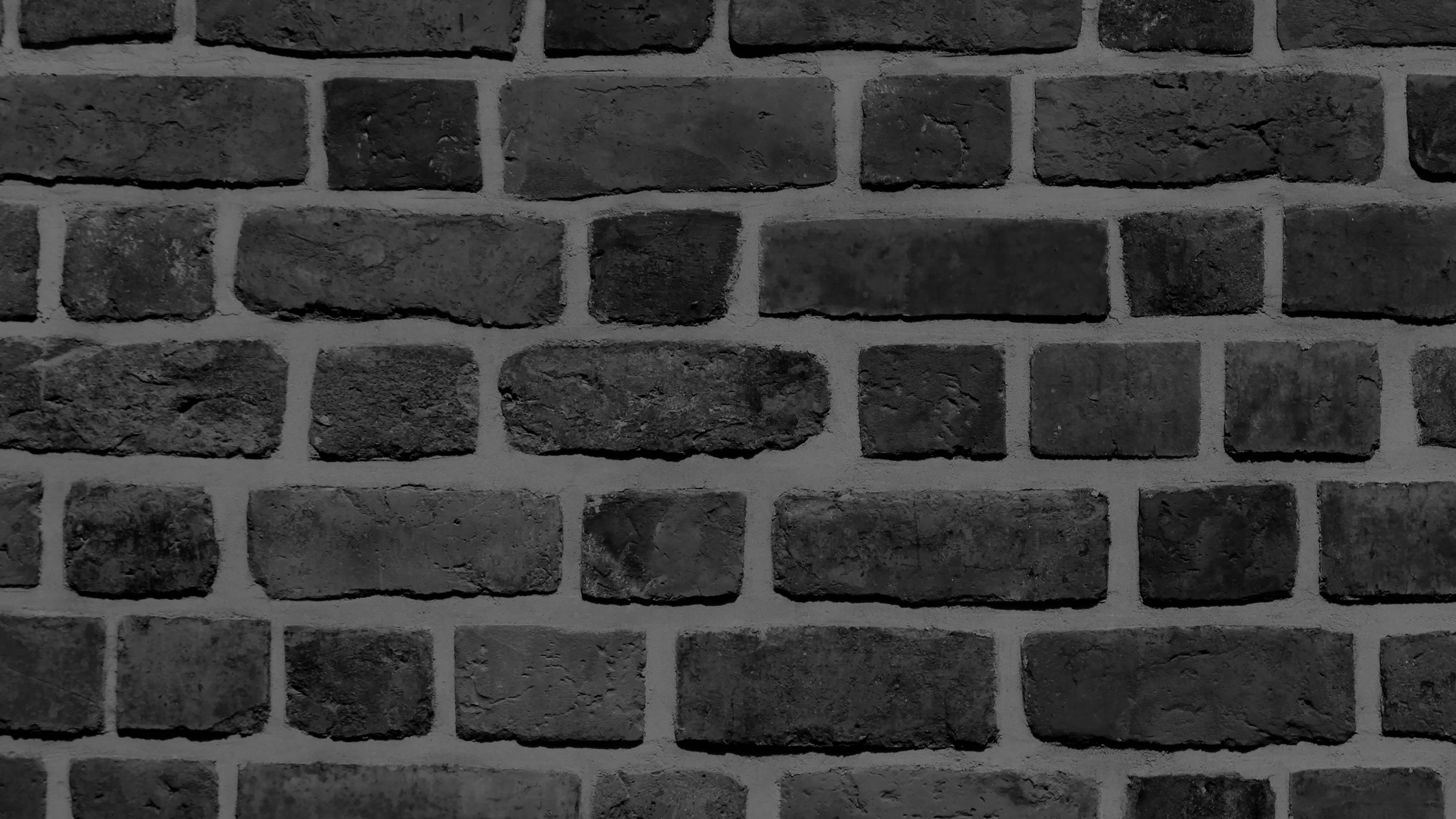 Brick 桌布 壁紙 — 經典交錯圖案中風化深灰色磚塊與淺灰色砂漿的特寫。