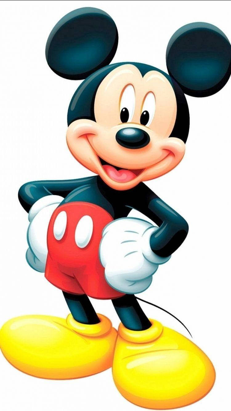Mickey 桌布 壁紙 — 經典卡通米奇老鼠穿著標誌性的紅色短褲和黃色鞋子，開心地微笑。