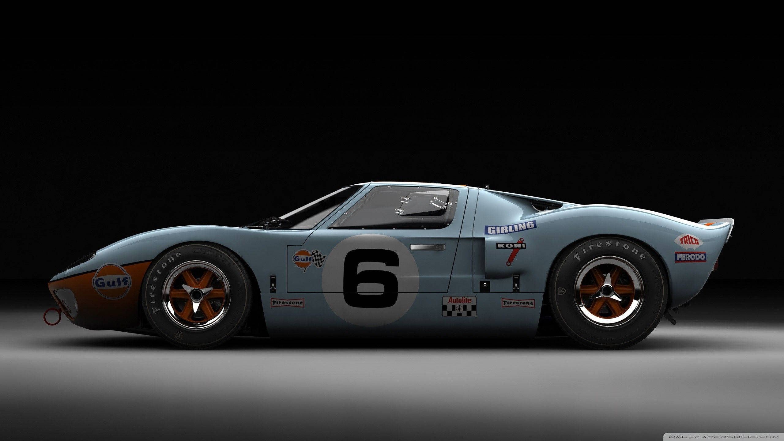 Racing 桌布 壁紙 — 經典淺藍色海灣福特GT40賽車，帶有6號和橙色點綴，在純黑背景前蓄勢待發。