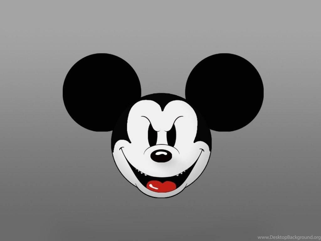 Mickey 桌布 壁紙 — 經典米奇老鼠臉孔，大耳朵和紅色舌頭，在灰色漸變背景上微笑。